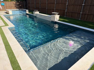 Modern Geometric Pool with Tile Waterfall Wall and Fire Bowls