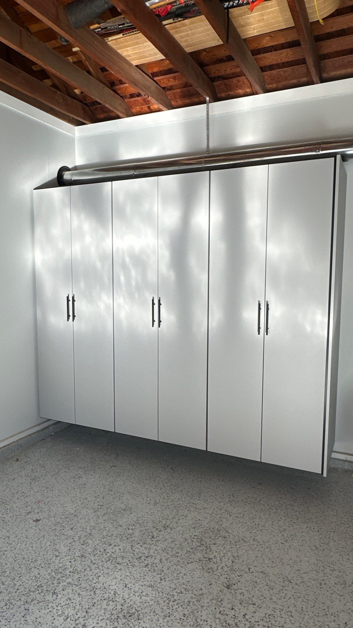 Jamie N added these beautiful cabinets for extra storage space by Banner Garage