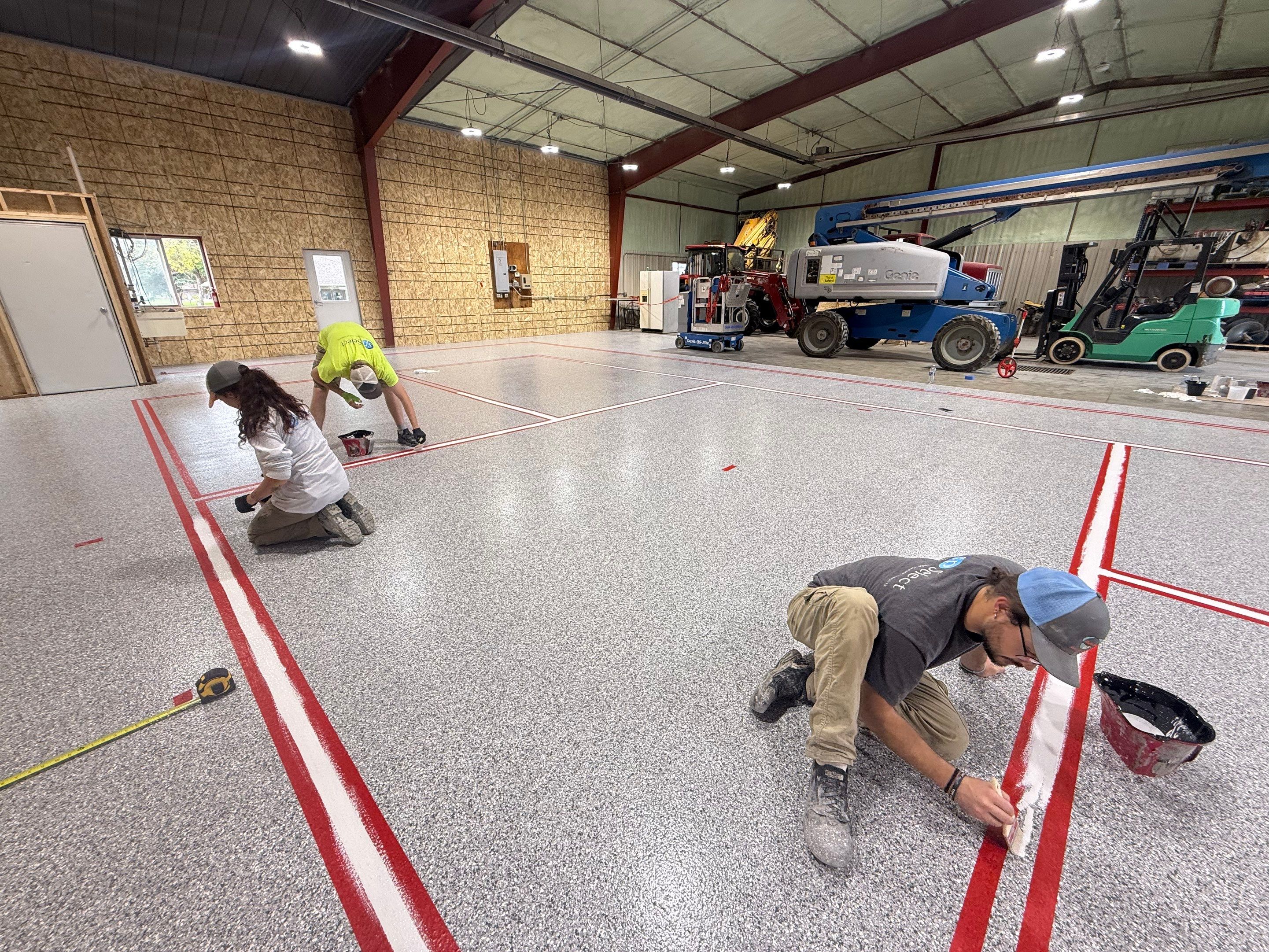 Custom Polyurea Shop Floor with Basketball Court Lines in Rock Valley by Select Painting, Coatings & Garage Cabinets