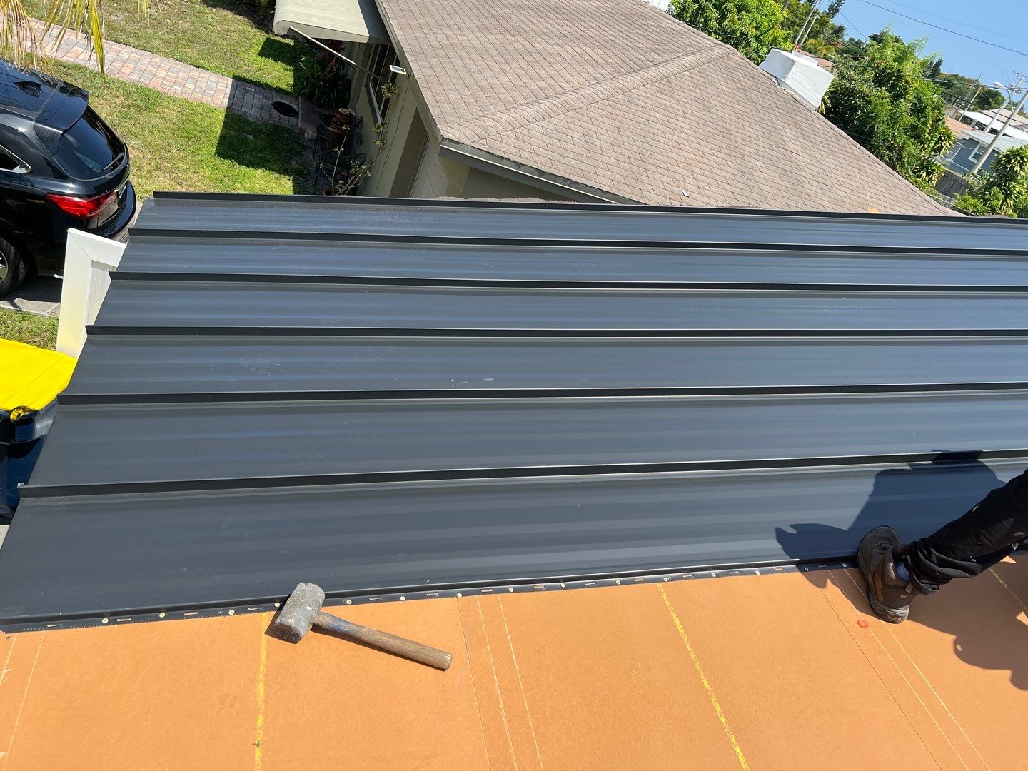 Standing Seam Metal & Flat Re-Roof using 1.5" Nail Strip 24ga Black Matte Kynar Coated Standing Seam Metal Panels by Morton Roofing, Inc.
