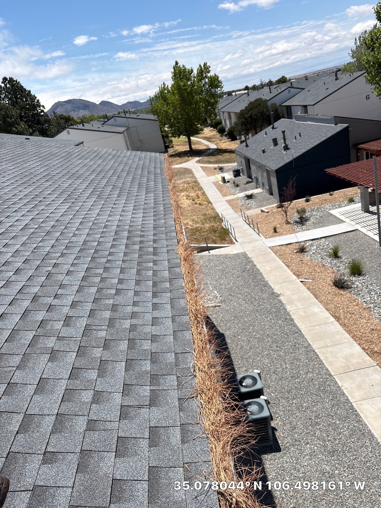 Commercial gutter cleaning Albuquerque before photo with filled gutters