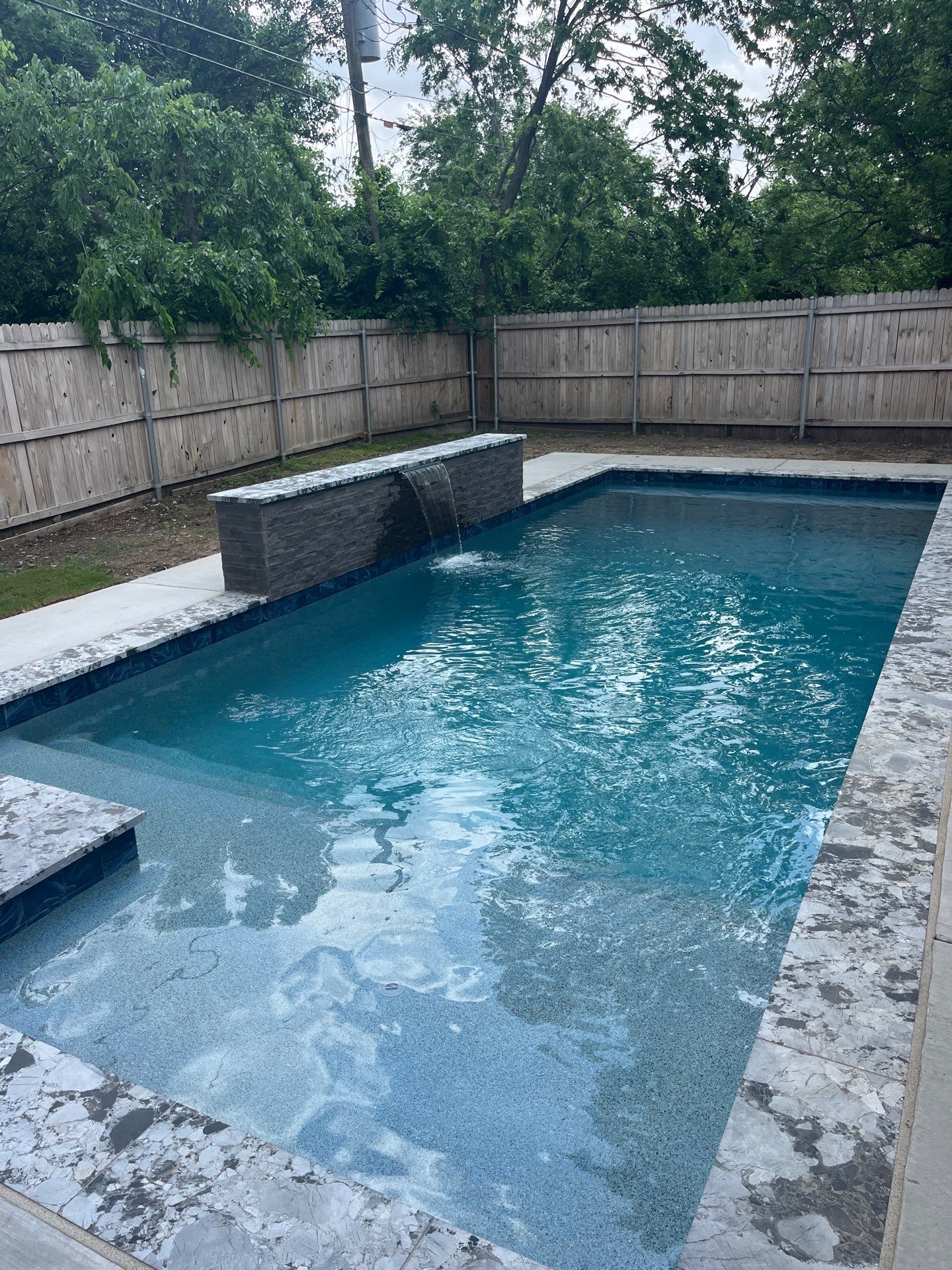 Geometric Pool with Stone Waterfall Wall by Pinnacle Pools and Spas - DFW