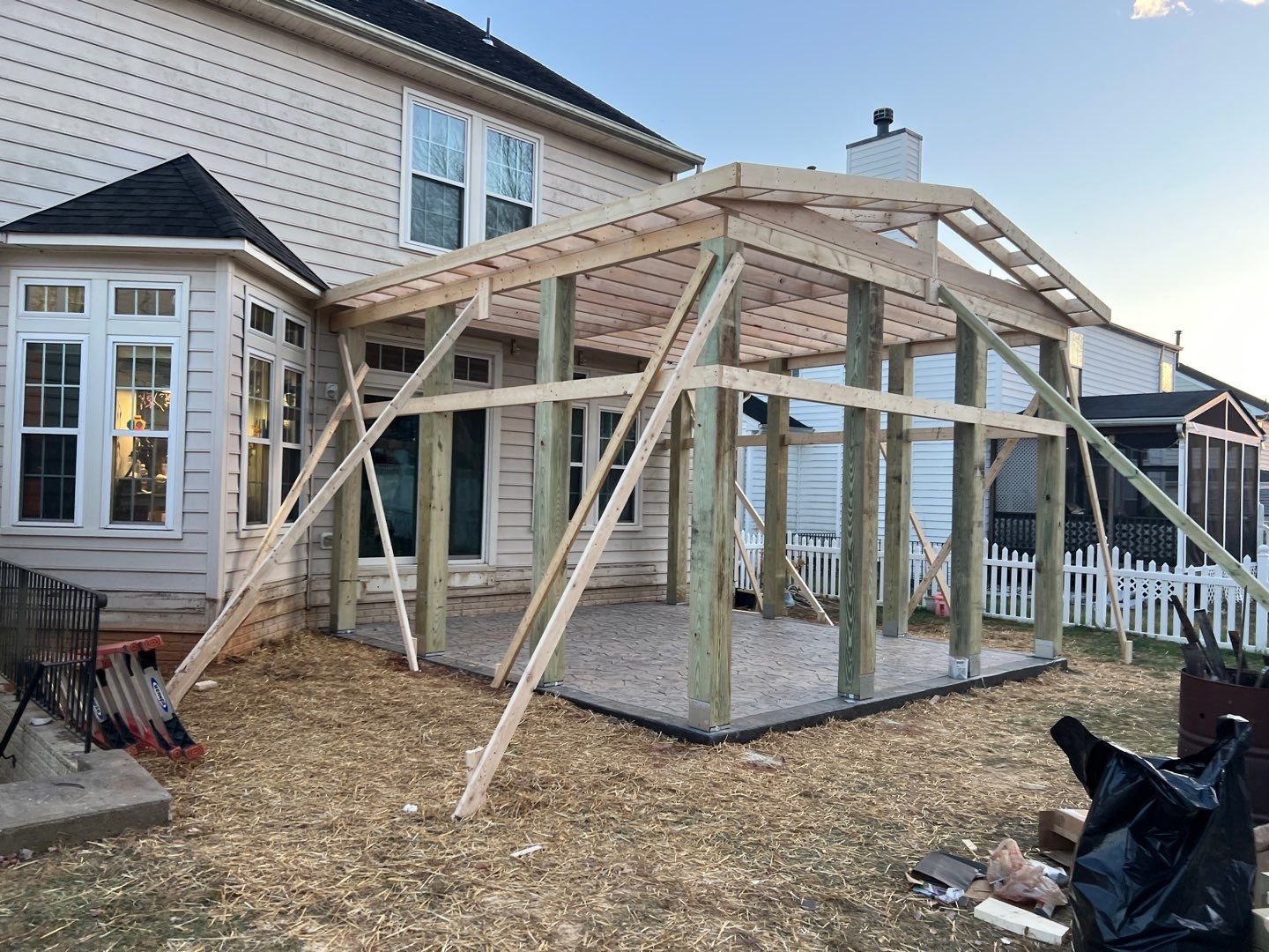 Custom Screened-In Porch with Stamped Concrete Patio in Warrenton by Jakari Restoration & Construction LLC