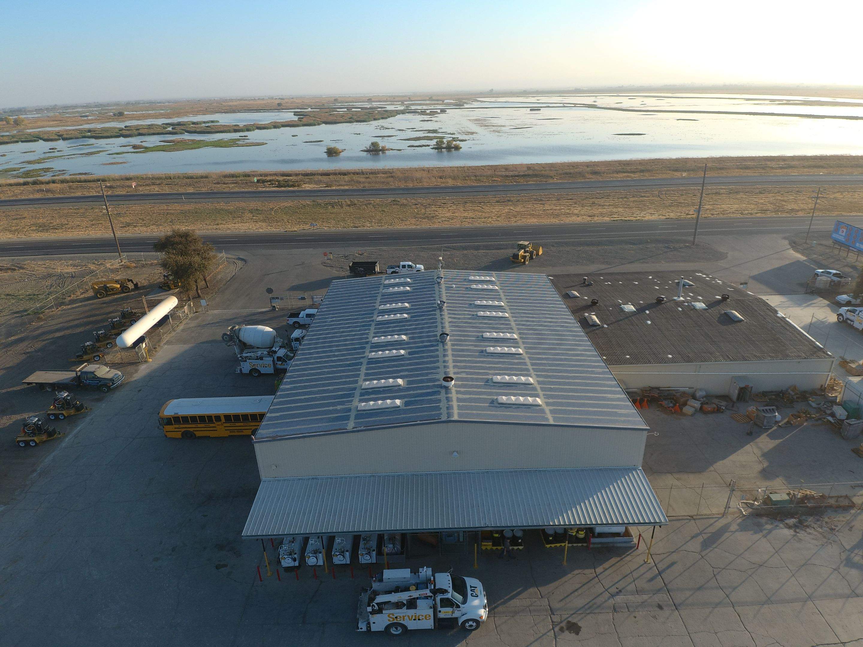 Metal roof restoration on commercial roof using Conklin Benchmark/ PUMA XL acrylic coatings over metal and foam by Straight Edge Roofing Inc