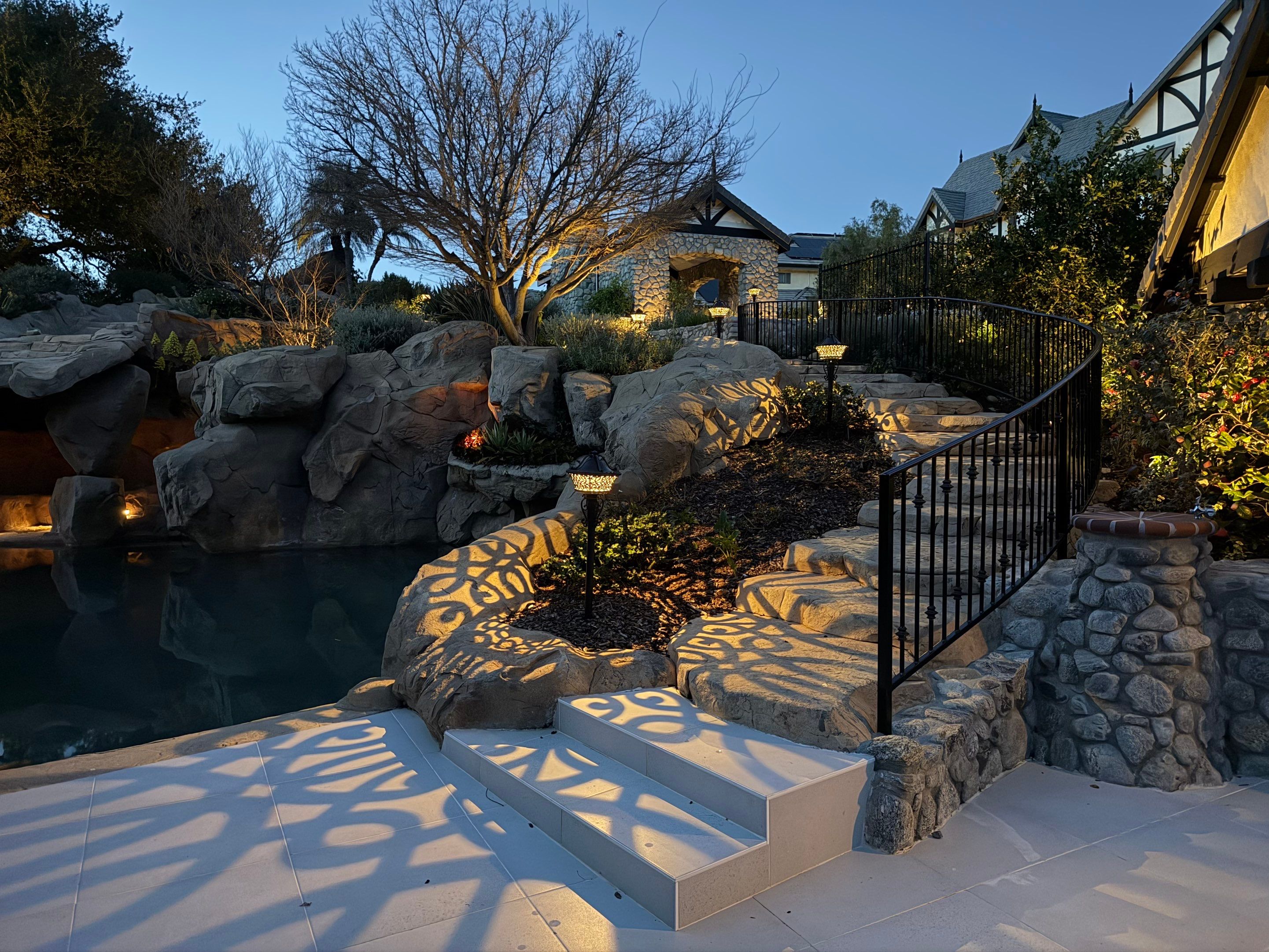 Tudor Estate Landscape Lighting with Integrated Stone Step Illumination by Outdoor Lights + Shades