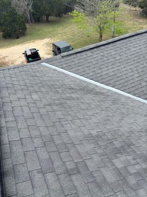 Asphalt shingle roof with two vehicles in the driveway.