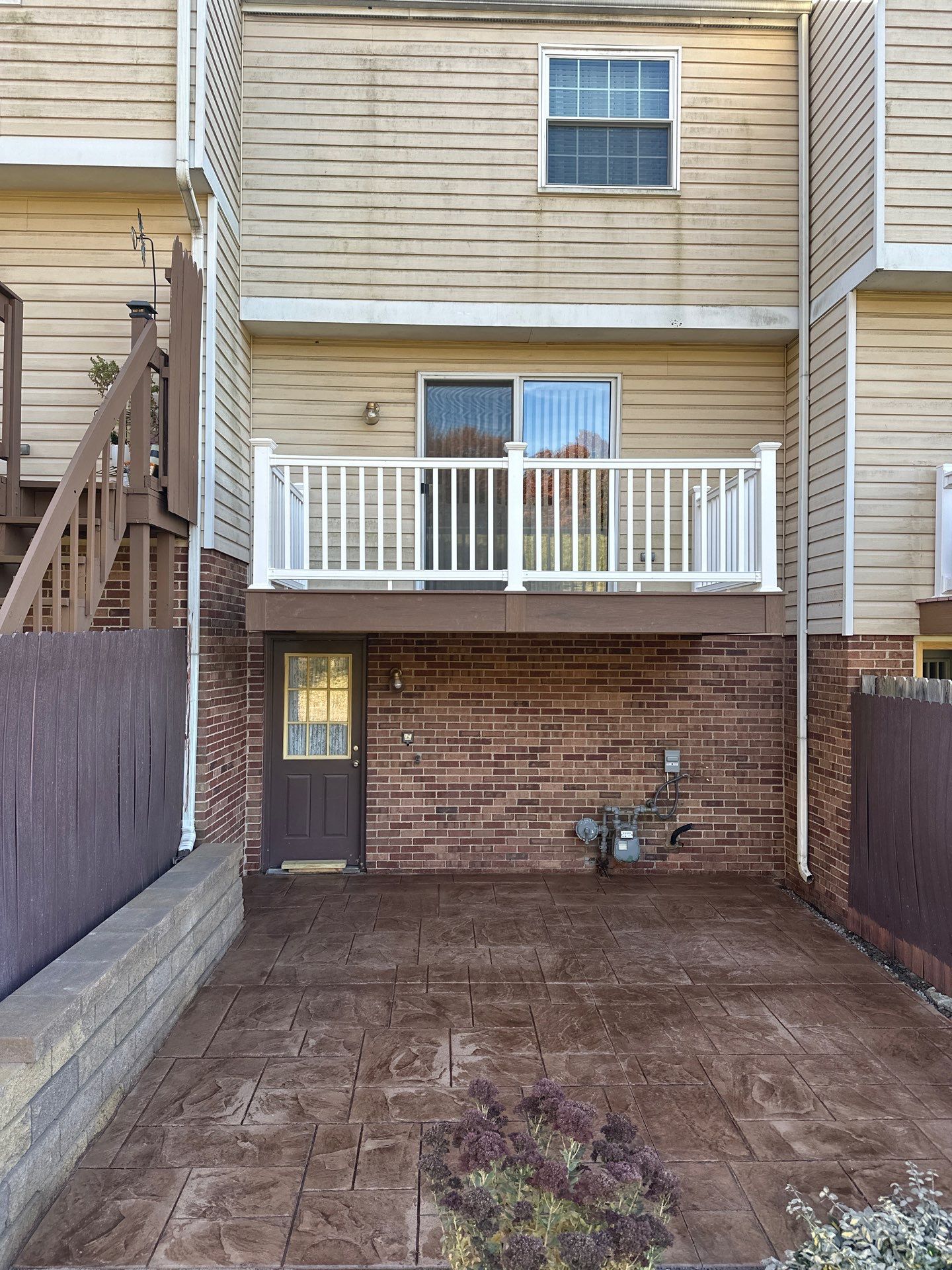Stamped concrete and redeck  by Cousins Roofing Siding & Decks