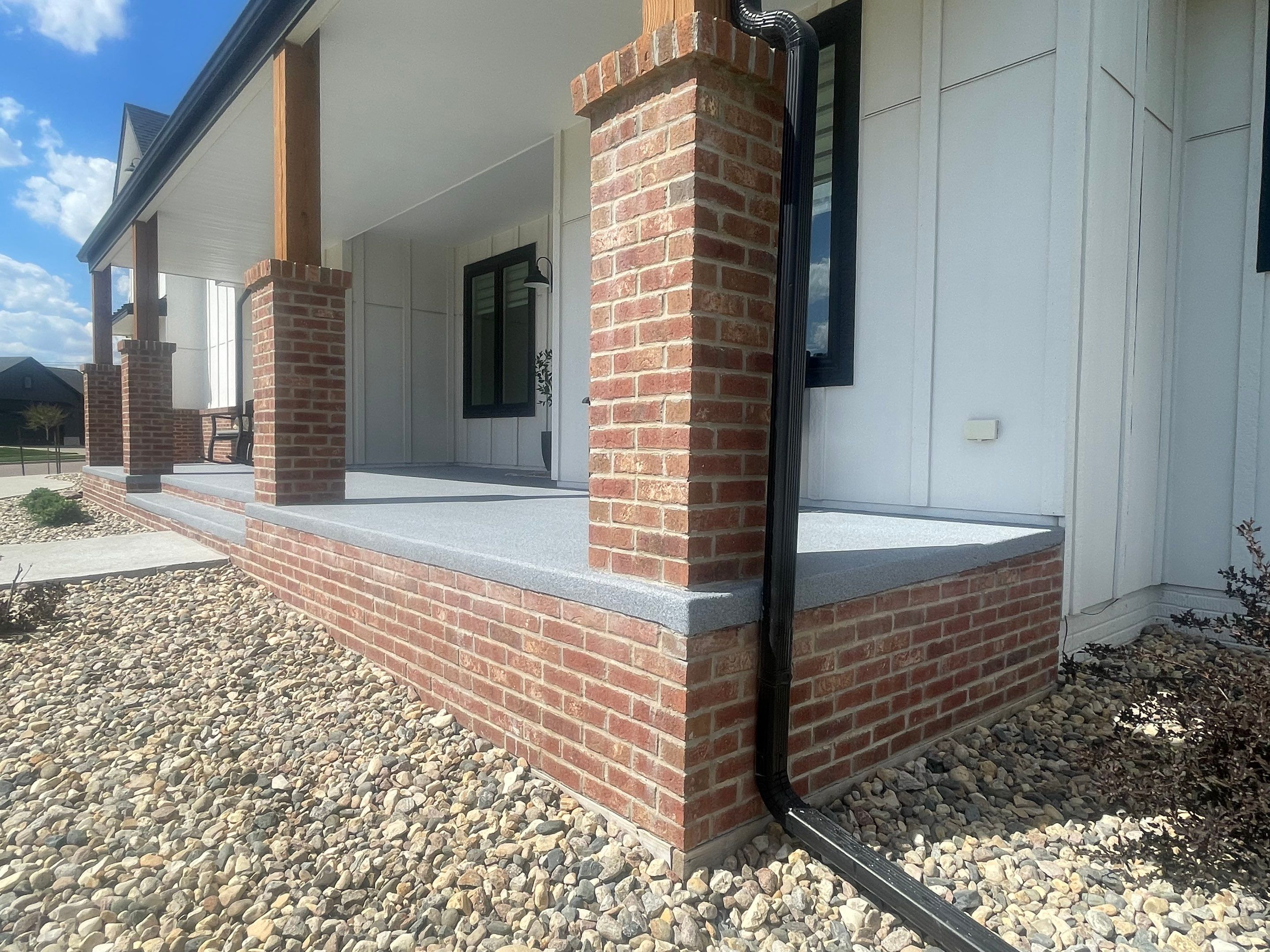 Grey Speckled Concrete Porch Coating for Sioux Falls Home by Select Painting, Coatings & Garage Cabinets