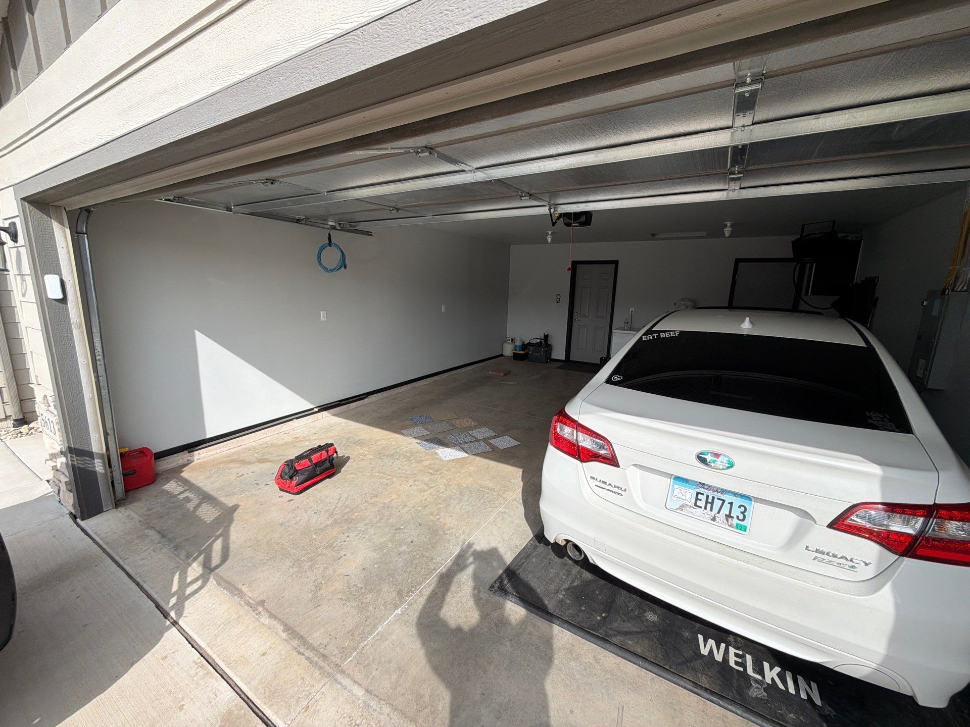 Custom Epoxy Garage Floor Coating Installation in Sioux Falls by Select Painting, Coatings & Garage Cabinets