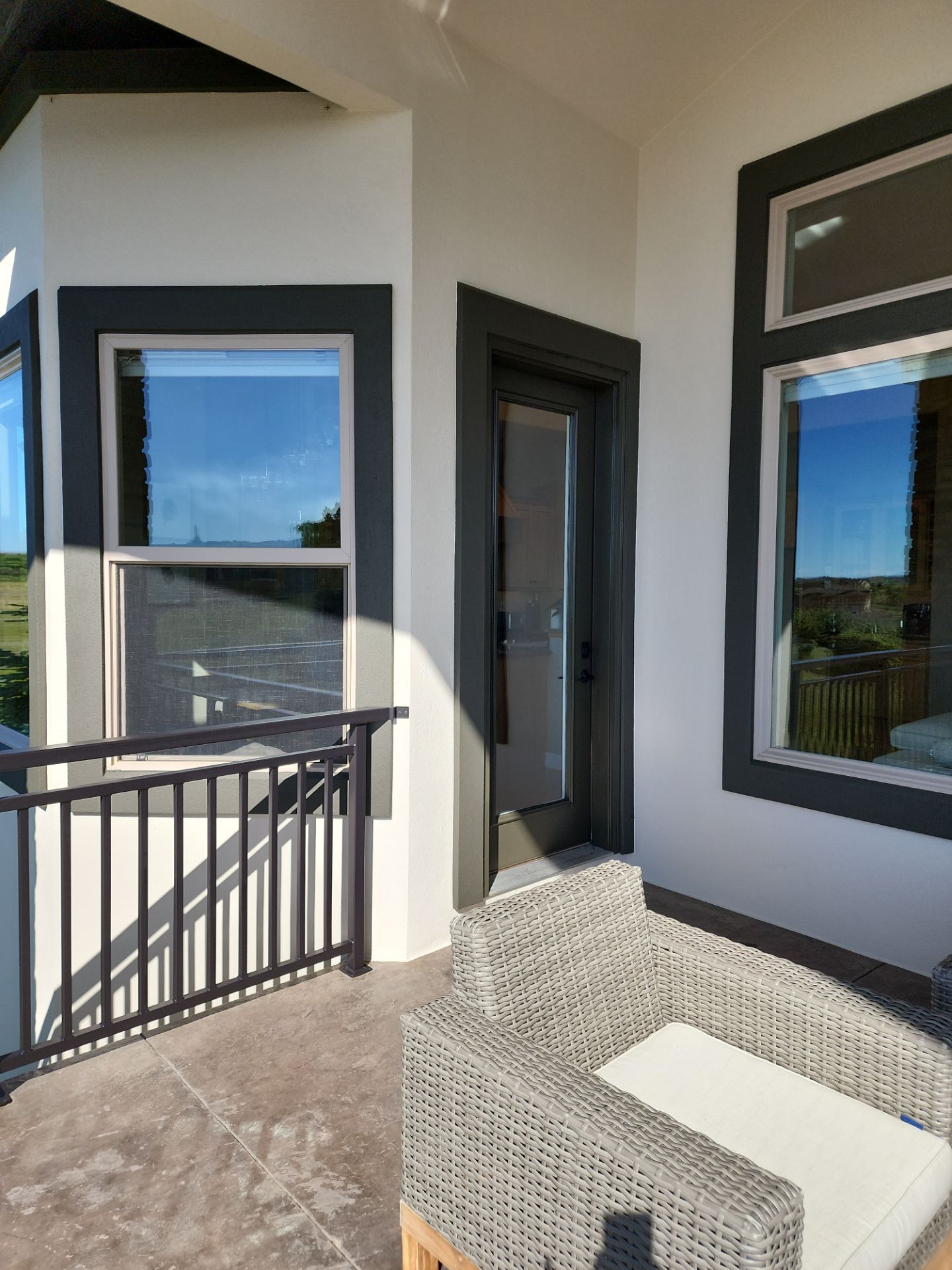 Castle Rock Elegance: White Stucco Exterior with Bold Tricorn Black by J&M Painting LLC