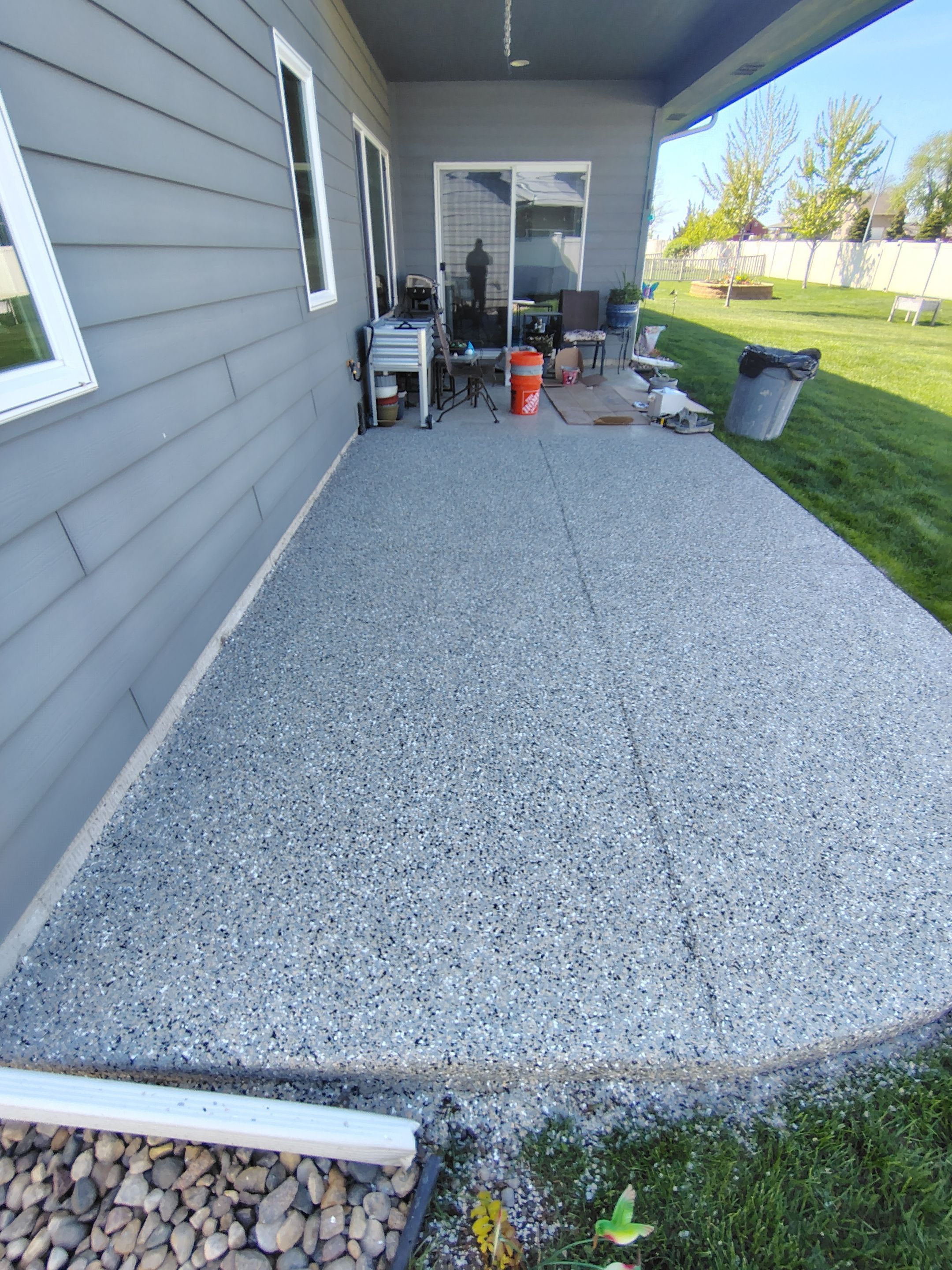 Speckled Concrete Patio Coating Installation in Sioux Falls by Select Painting, Coatings & Garage Cabinets