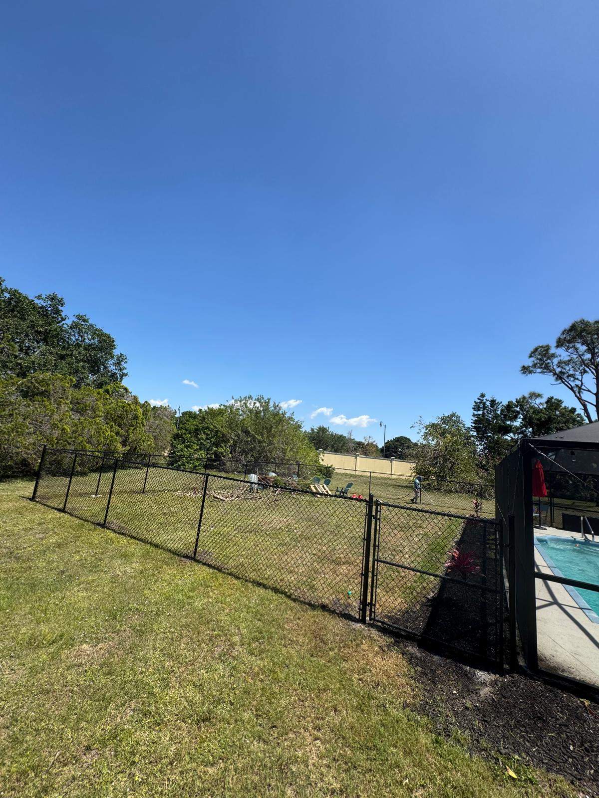 Black Chain Link Residential Backyard Fence Installation in North Port by True Fence LLC