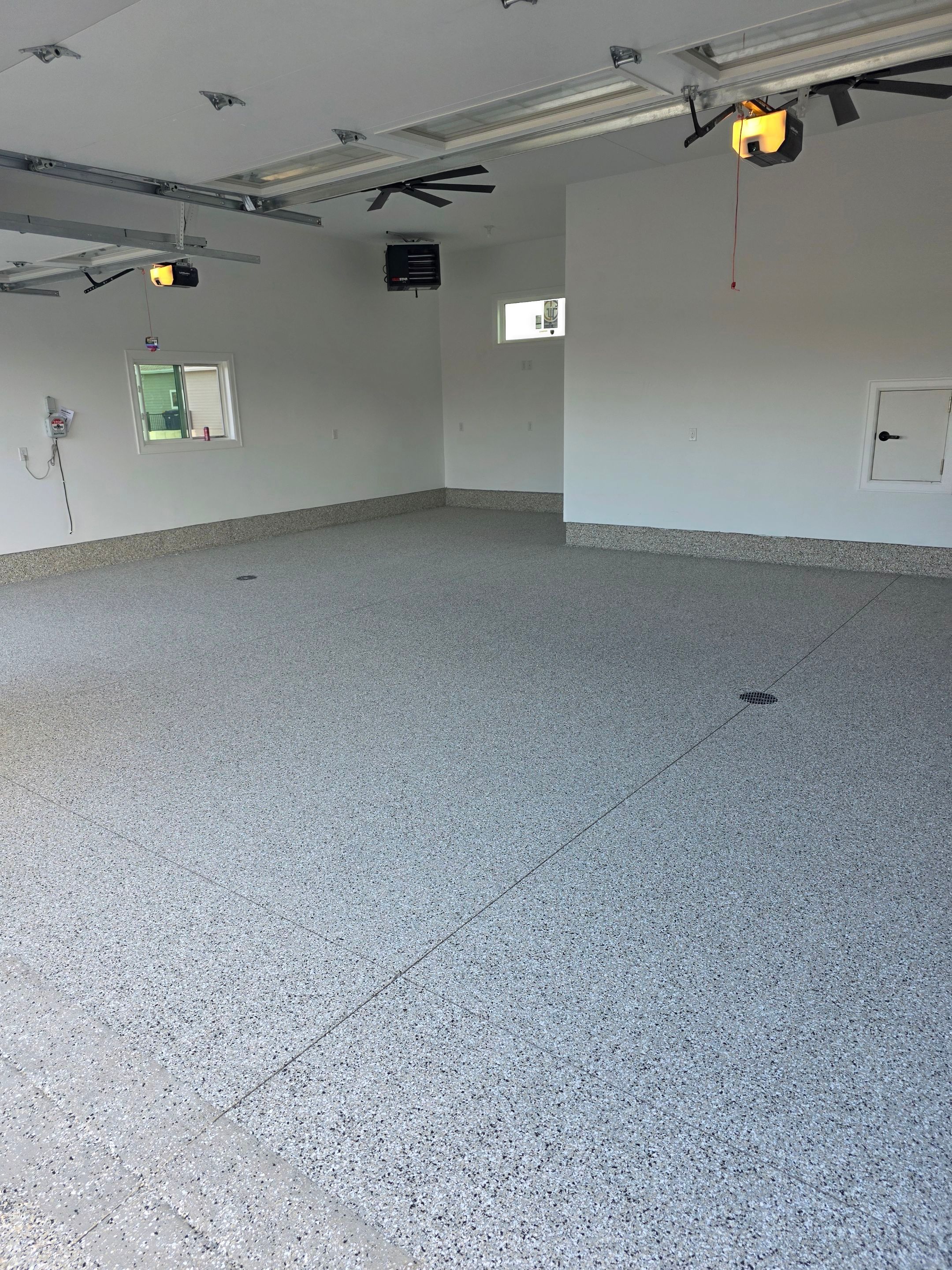 Gray and Black Speckled Polyurea Garage Floor in Dell Rapids by Select Painting, Coatings & Garage Cabinets