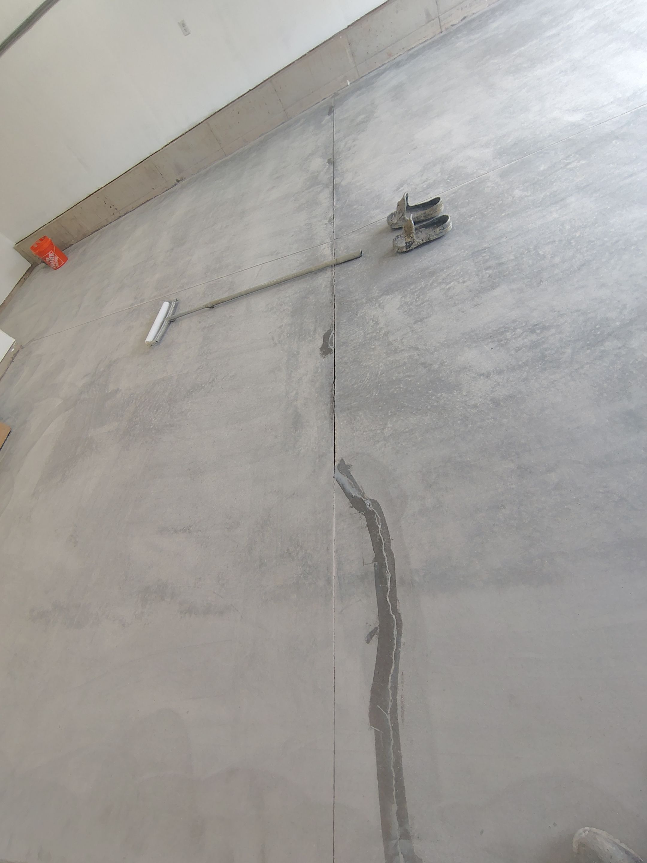Sioux Falls Garage Floor Transformation With Gray Speckled Epoxy Coating by Select Painting, Coatings & Garage Cabinets