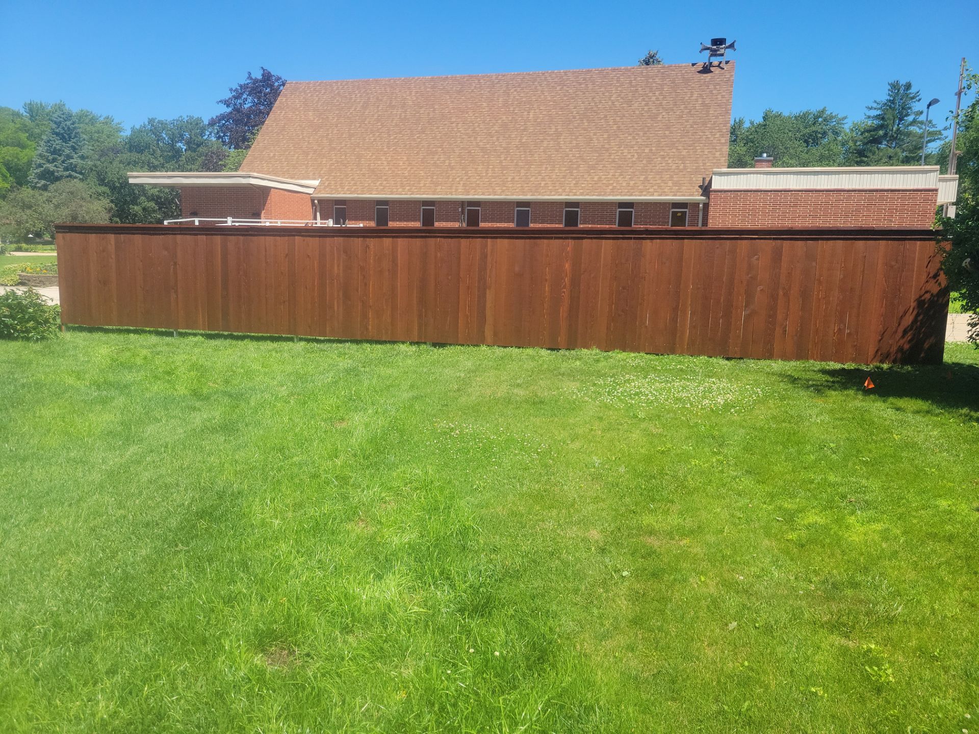 Custom Stained Cedar Chestnut Privacy Fence Installation in Cedar Falls by Perfect Picket Fence and Stain