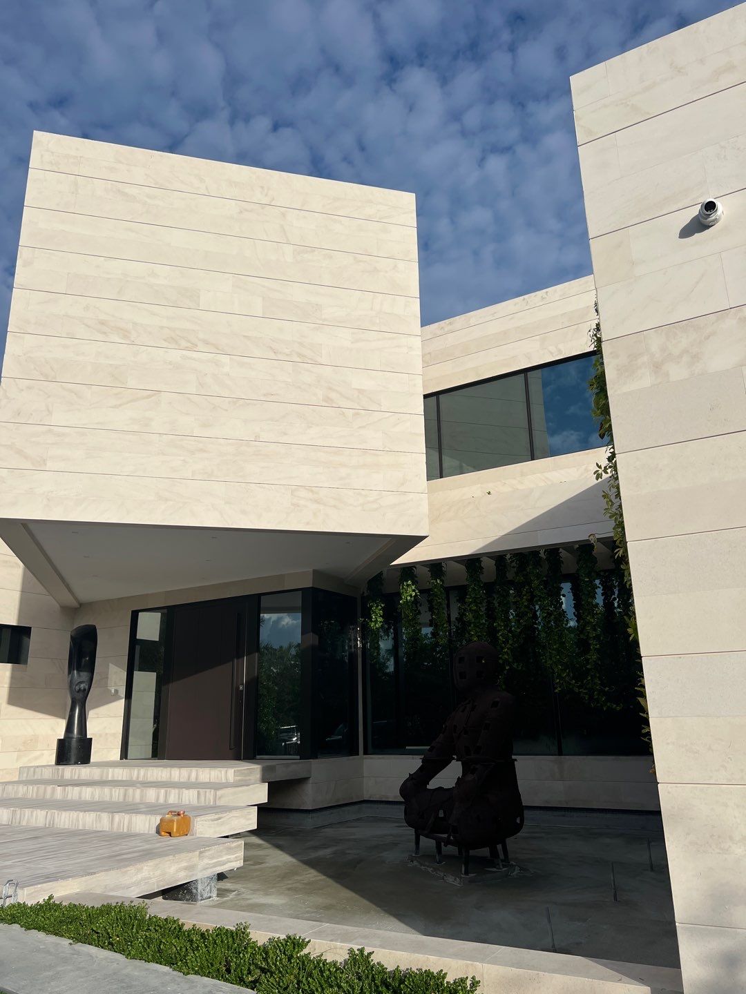 Custom Material Pivot Door installation by Impact Precious Wood Inc.