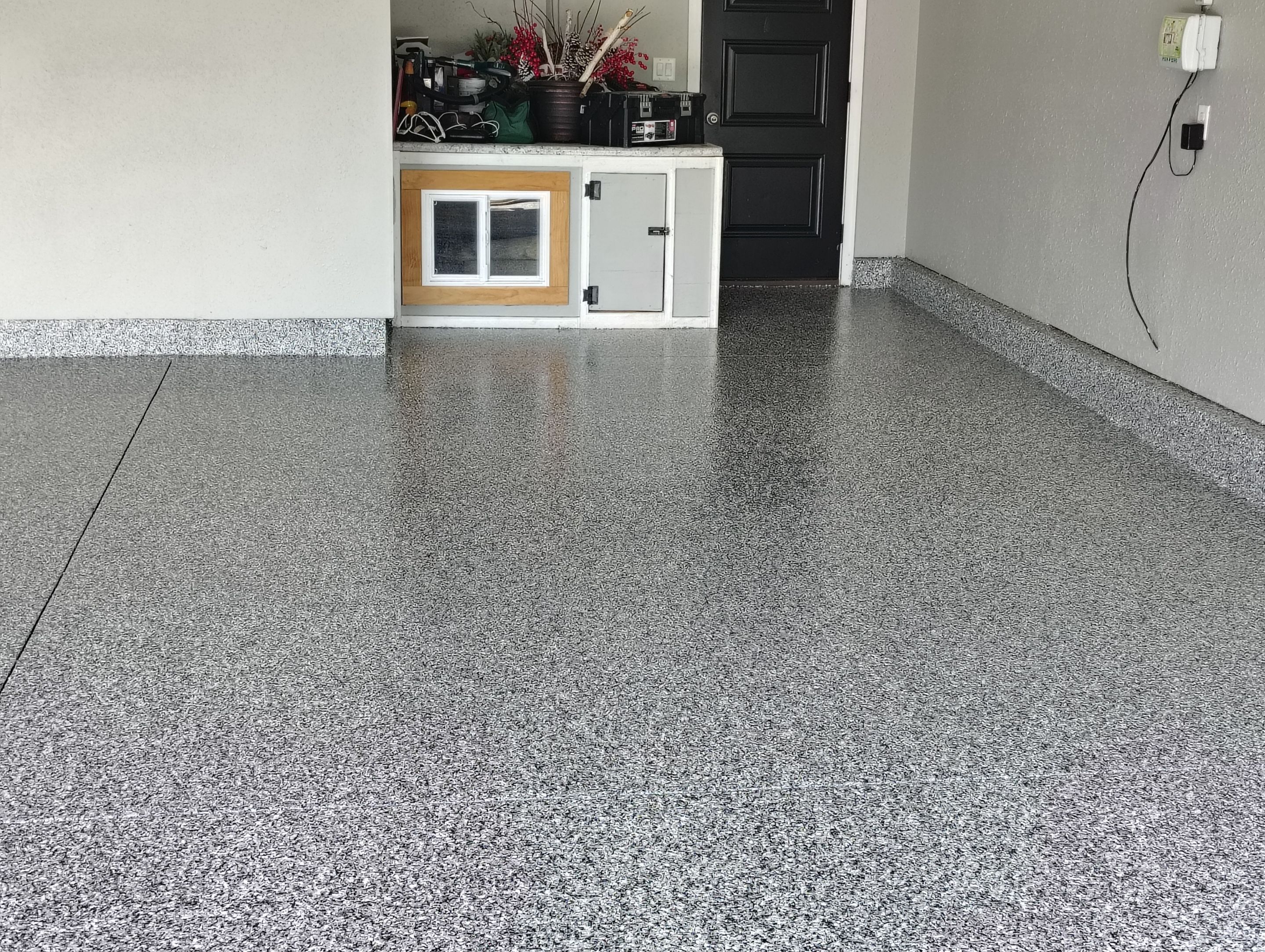 Custom Gray Flake Garage Floor Coating in Sioux Falls by Select Painting, Coatings & Garage Cabinets