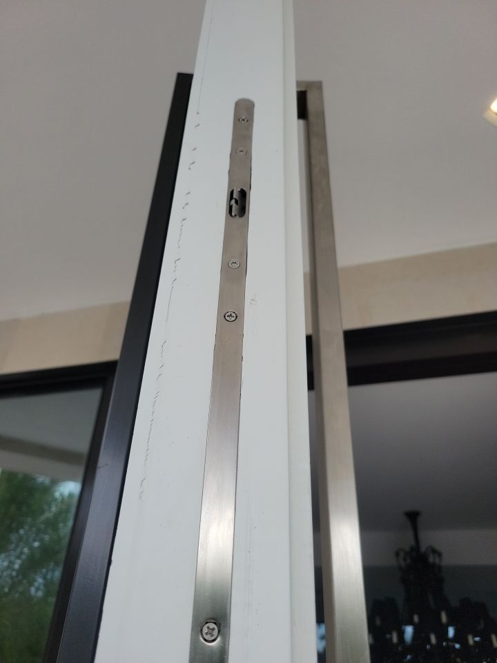 Custom Material Pivot Door installation by Impact Precious Wood Inc.