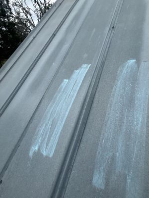 Close up of metal roof panel with chalk markings