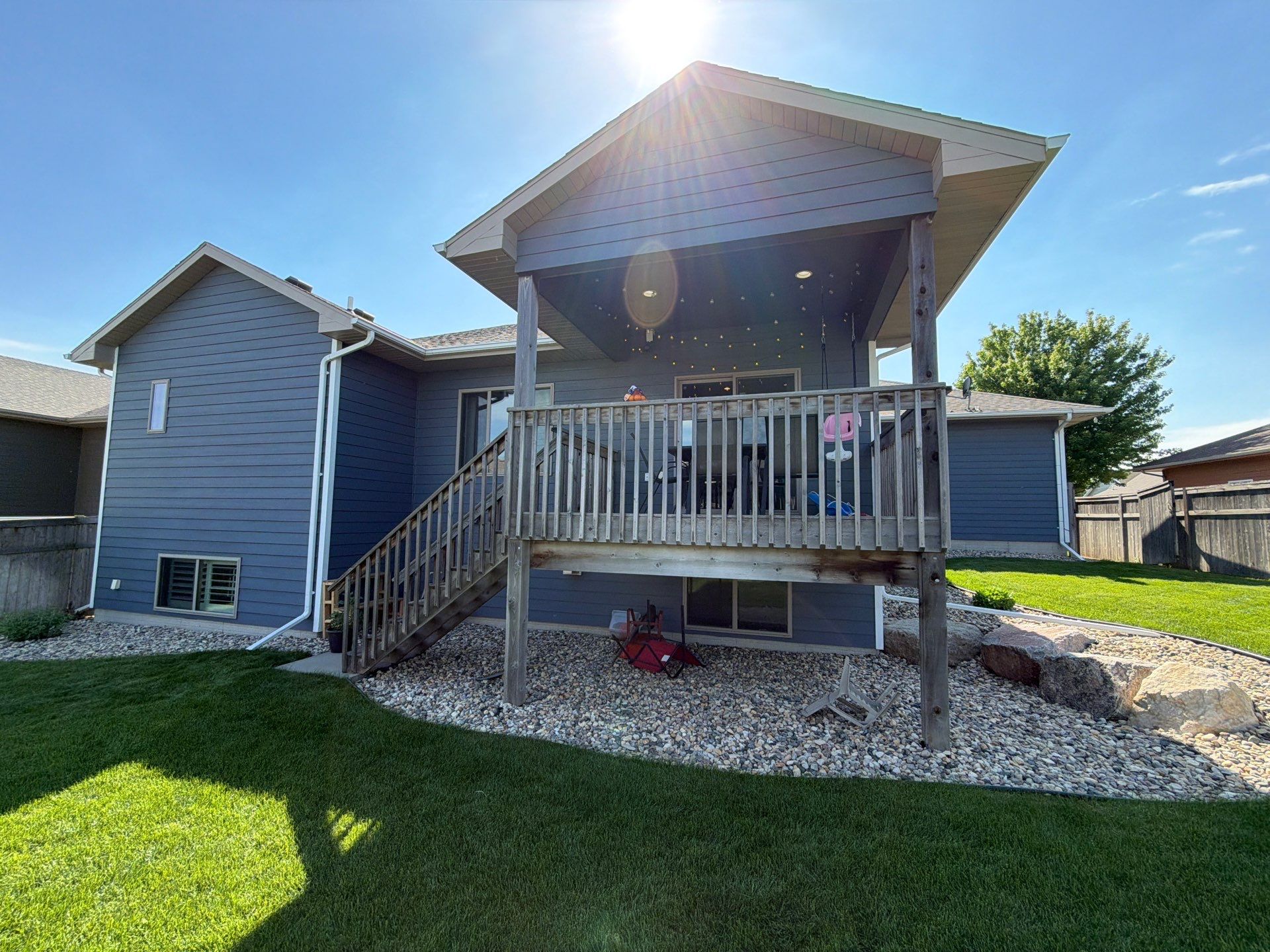 Full Exterior Home Painting on Blue Lap Siding in Sioux Falls by Select Painting, Coatings & Garage Cabinets