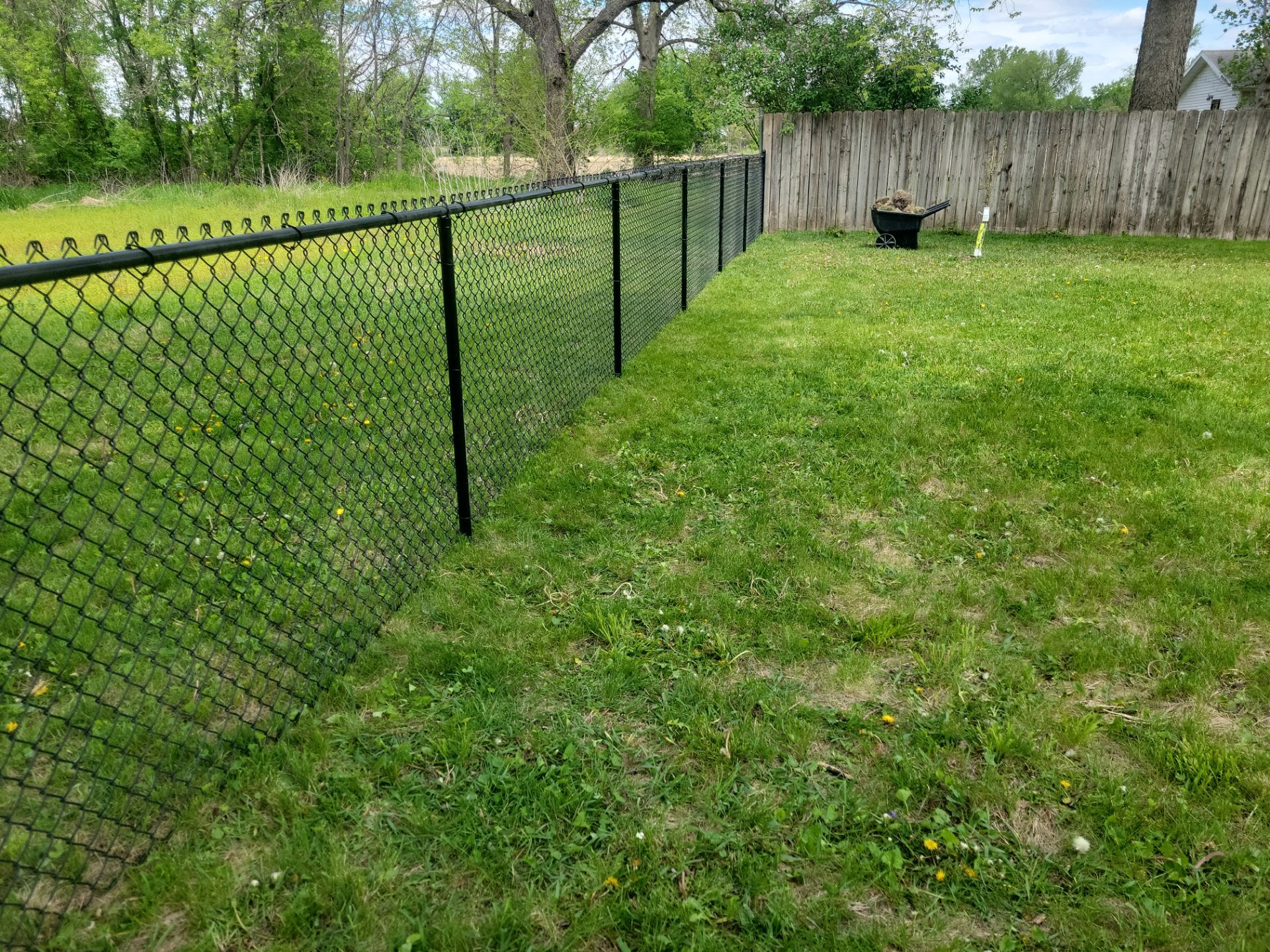 Black Chain Link Fence Installation and Gate in Traer by Perfect Picket Fence and Stain