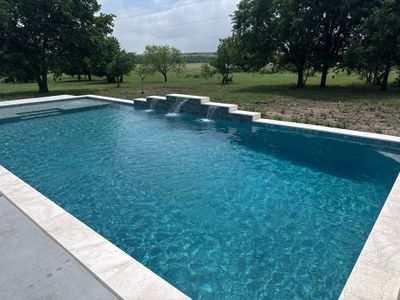 Expansive Geometric Pool with Countryside Views