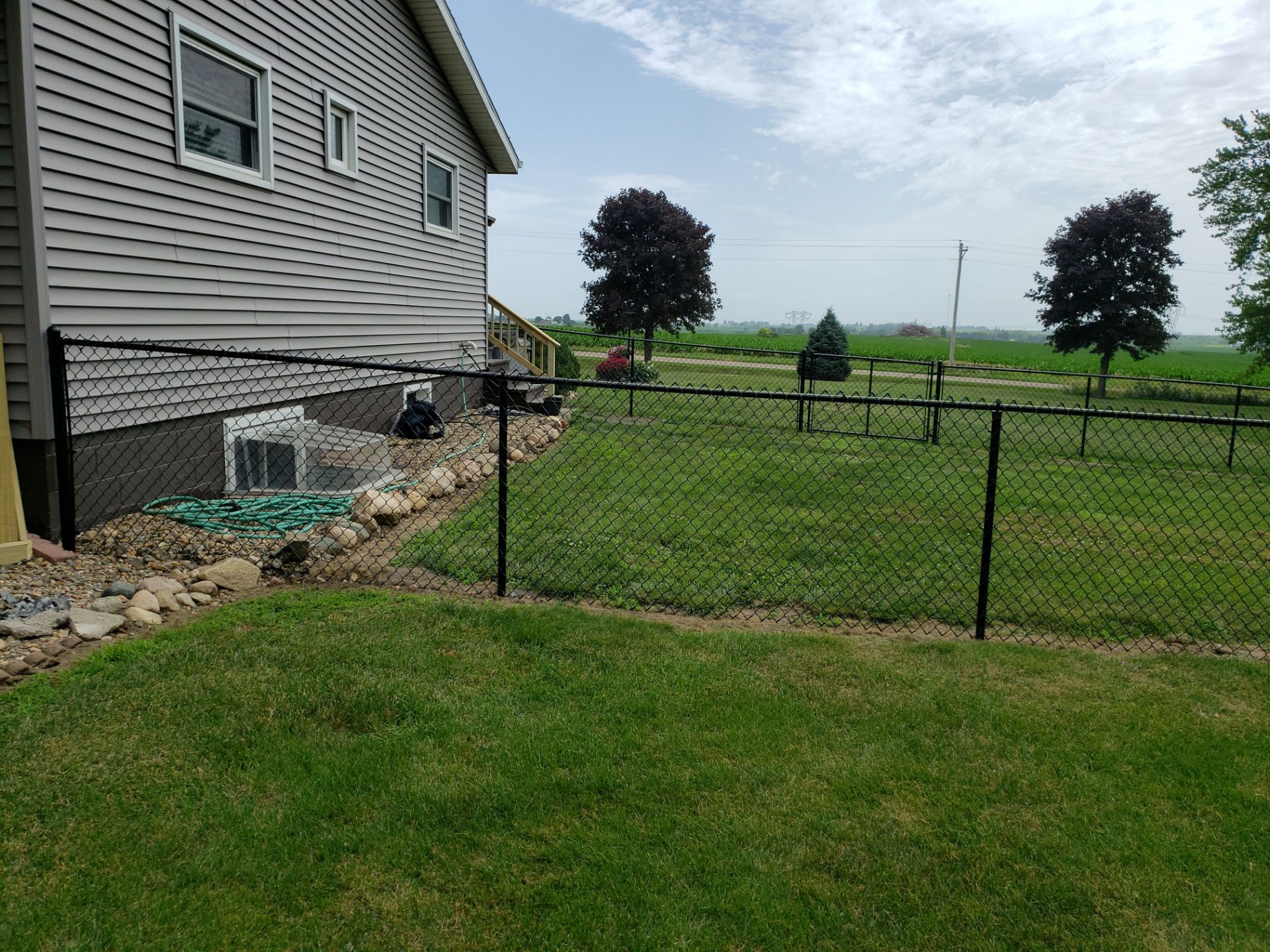 Black Vinyl-Coated Chain Link Fence Installation in Fredericksburg by Perfect Picket Fence and Stain