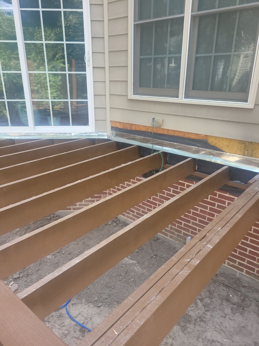 Fuquay-Varina Outdoor Upgrade – Composite Deck & Paved Landing by Elite Remodeling and Design LLC