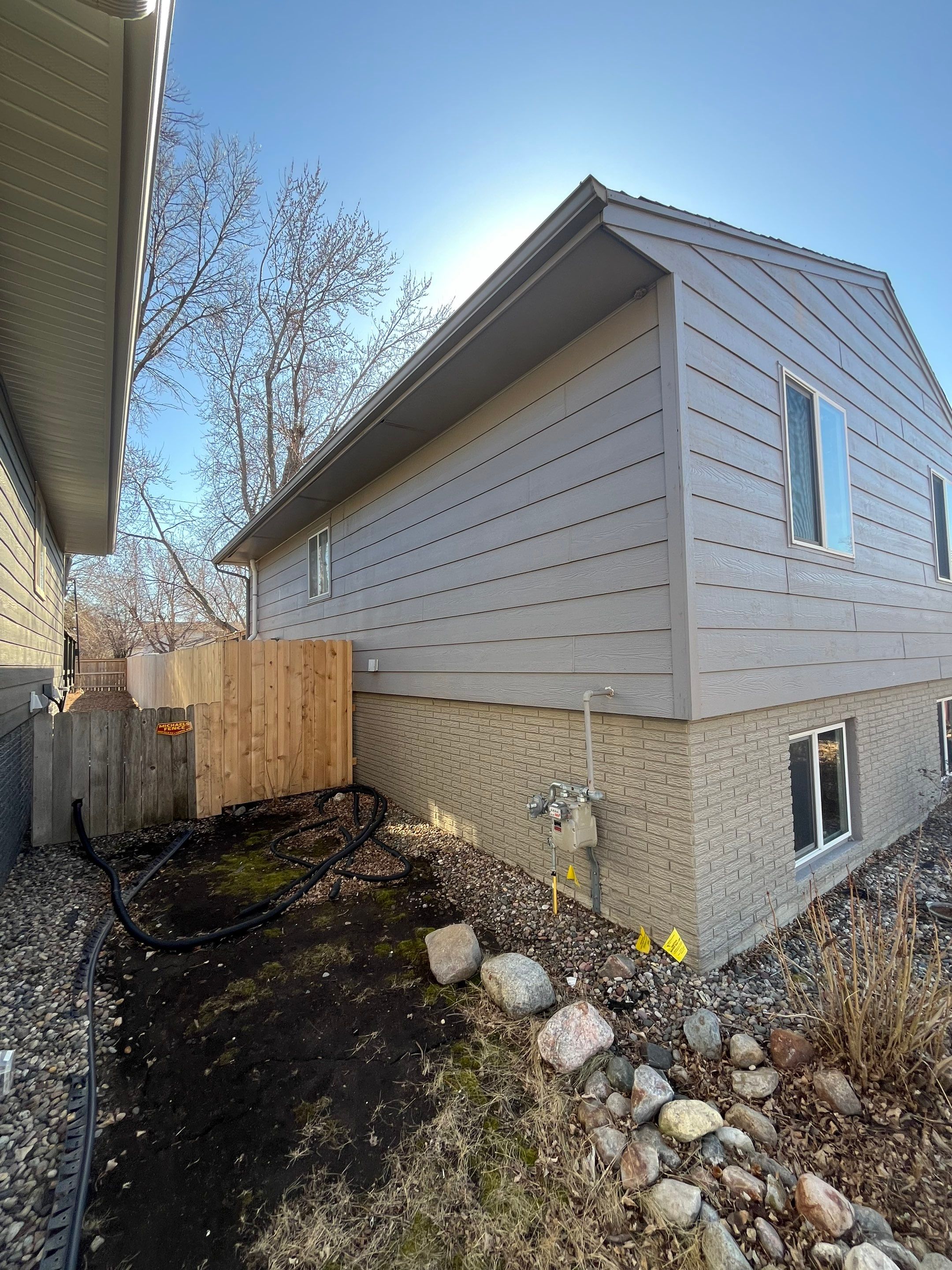 Full Exterior House Painting and Foundation Refinishing in Sioux Falls by Select Painting, Coatings & Garage Cabinets
