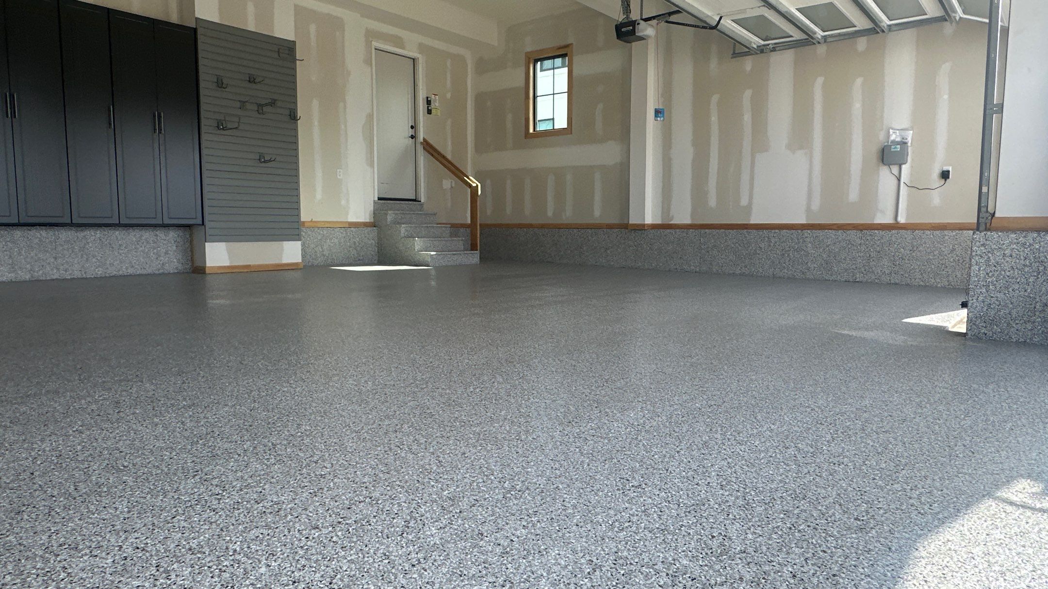 Megan J. added cabinets and slotwall to her garage. Plus a New Floor by Banner Garage