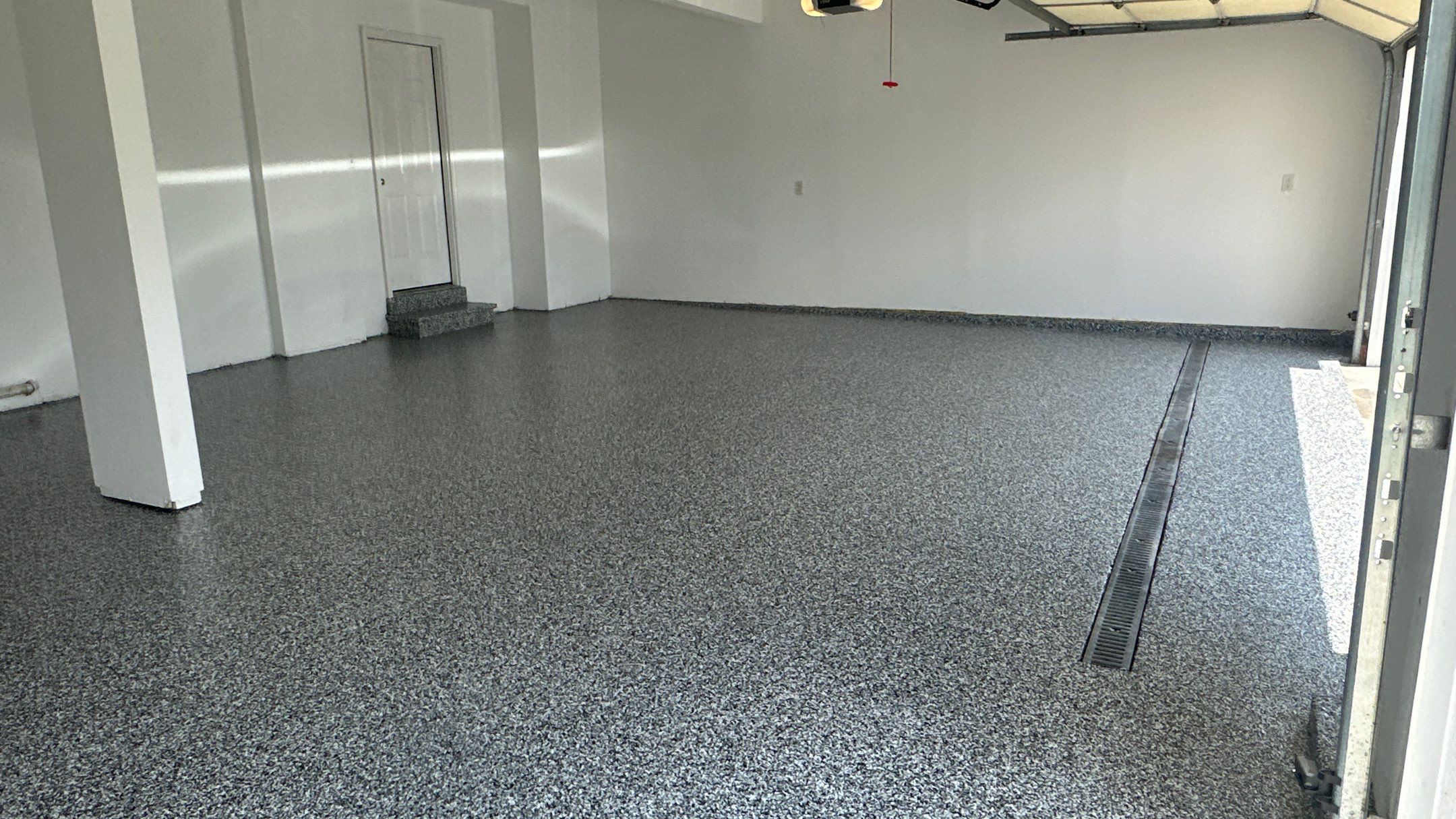 Laura B. garage transformation with a new floor and garage storage  by Banner Garage