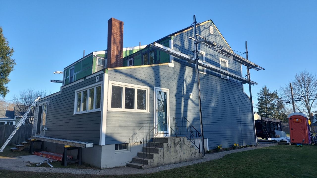 James Hardie siding, new metal roof and couple windows being installed. by UBrothers Construction