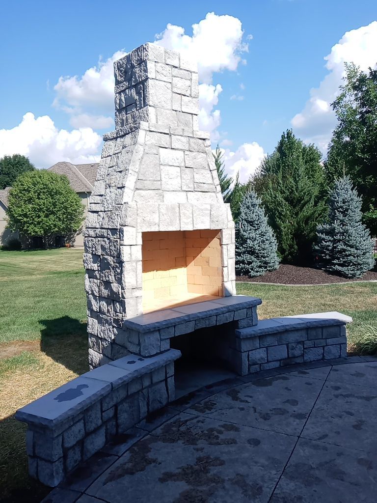Back Yard Fireplace and Landscape by LAND ESCAPES LLC