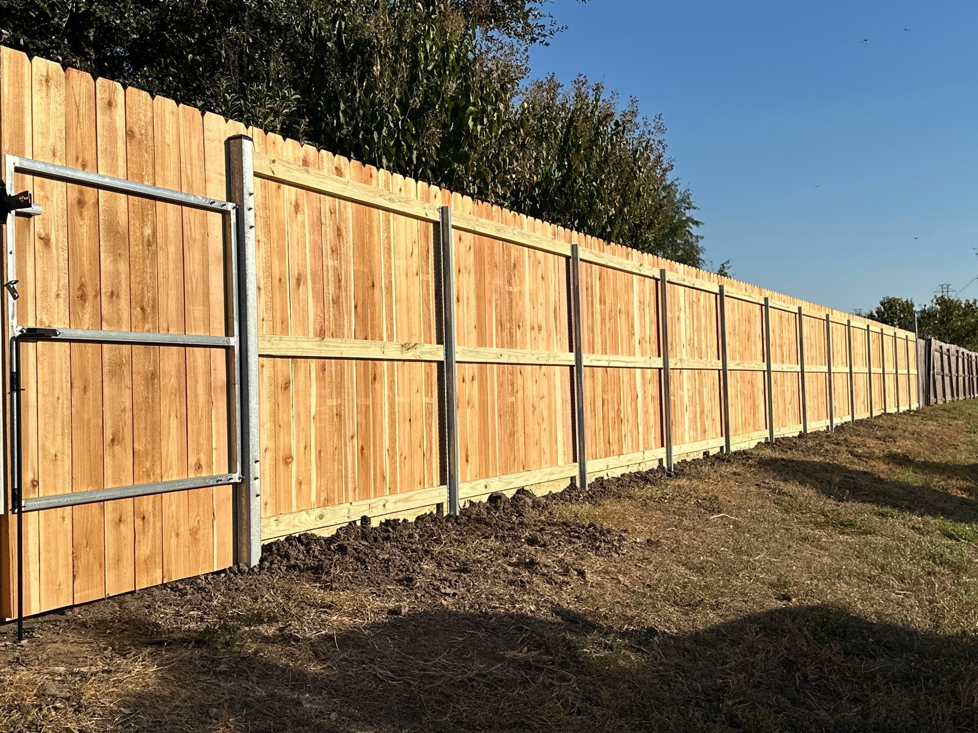 Beautiful Wood fence with metal posts by Tim's Fences