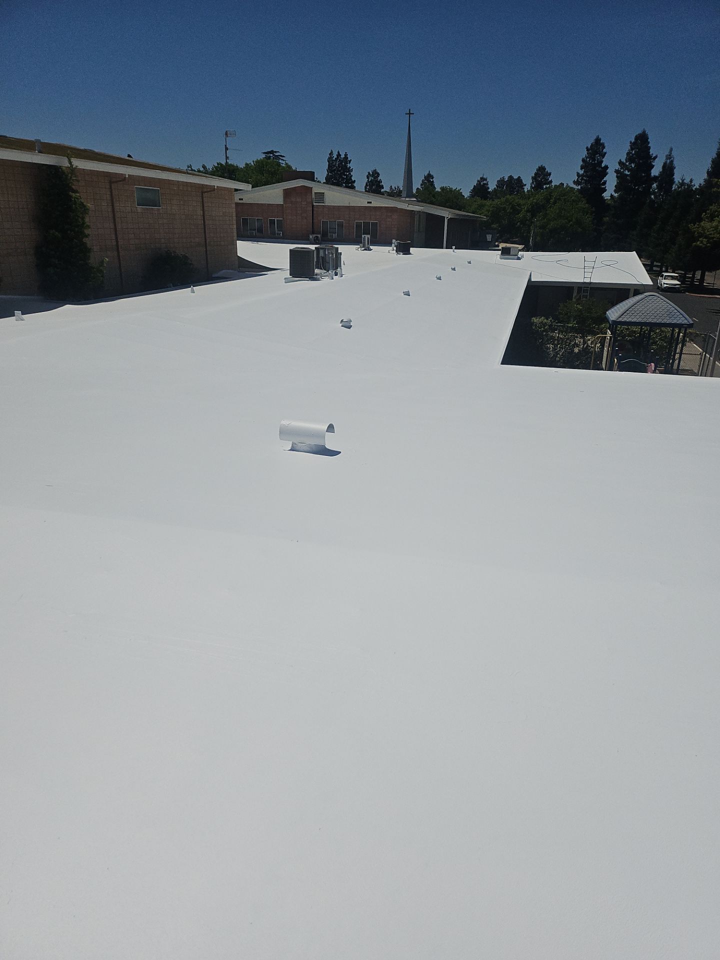 Single-ply restoration system using Benchmark/PUMA XL coatings over TPO single-ply roofing by Straight Edge Roofing Inc