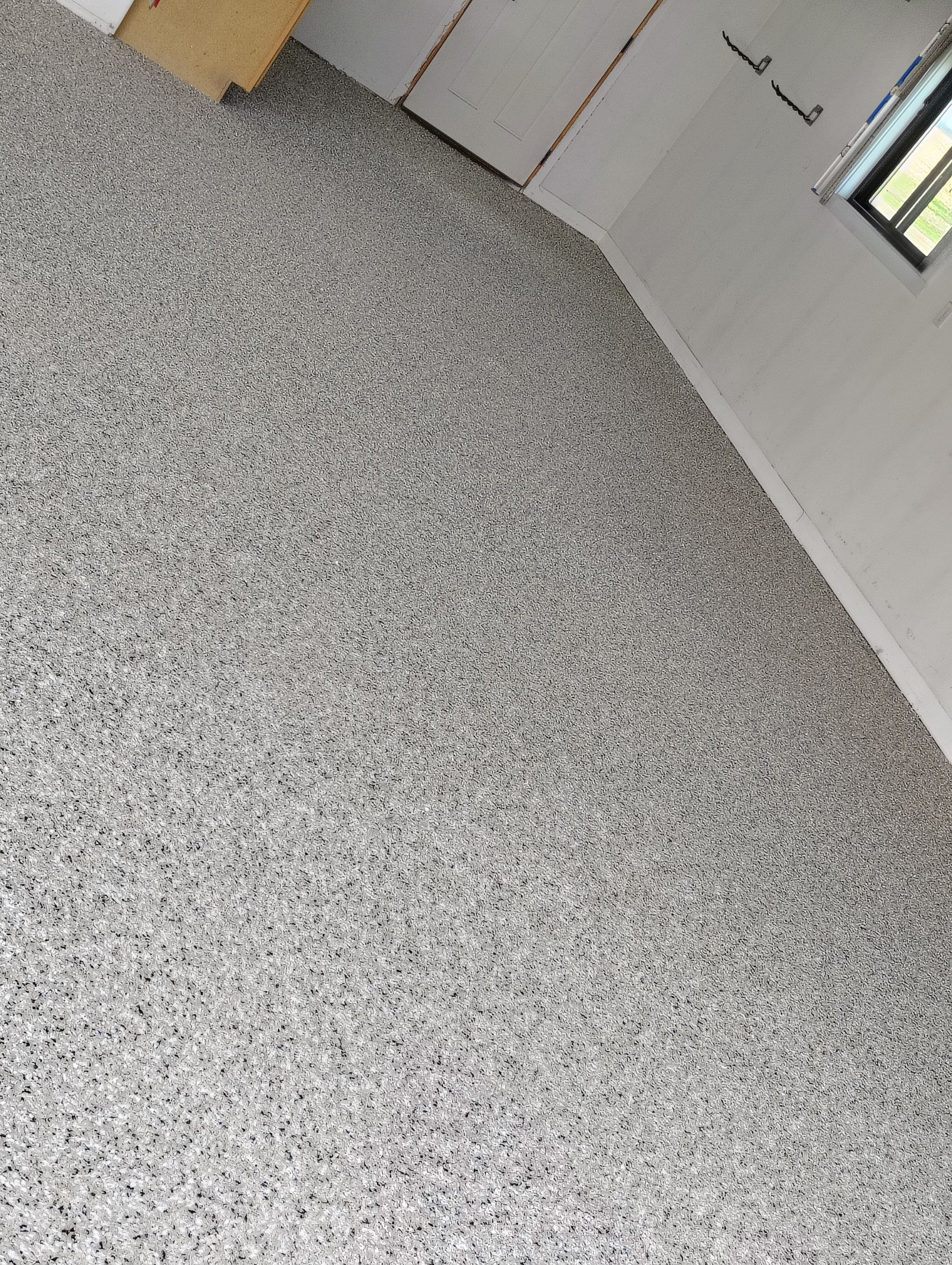 Speckled Polyaspartic Garage Floor Coating Installation in Dell Rapids by Select Painting, Coatings & Garage Cabinets