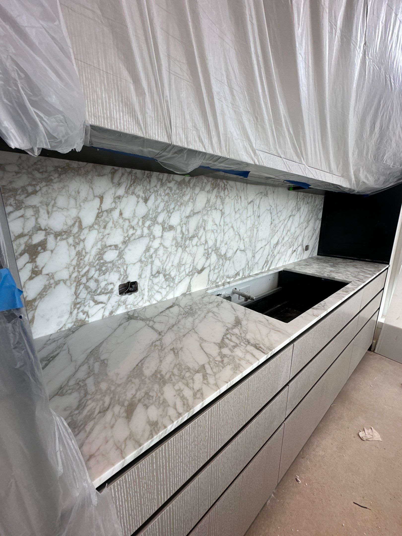 Kitchen Countertop with backsplash and Island top with mitered waterfalls by NC Stone And Tiles