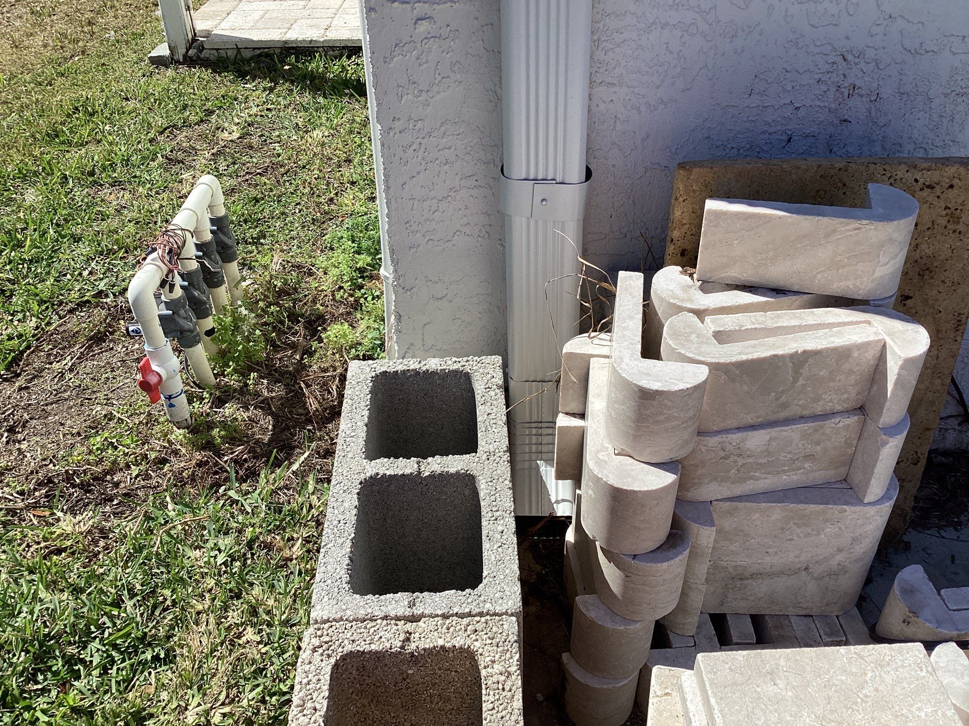 Brown Gutter + White and Brown Downspouts in Cape Coral FL by Gutter Professors