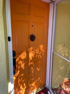 The exterior refresh of this classic Kansas City home is brought to life with timeless neutrals and a bold Sherwin-Williams Naval front door for a striking, welcoming finish.