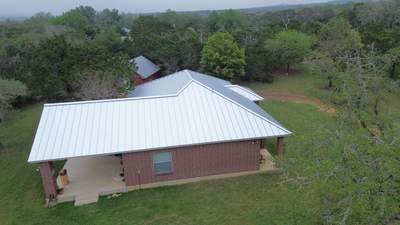 Side angle of standing seam metal roof on brick house
