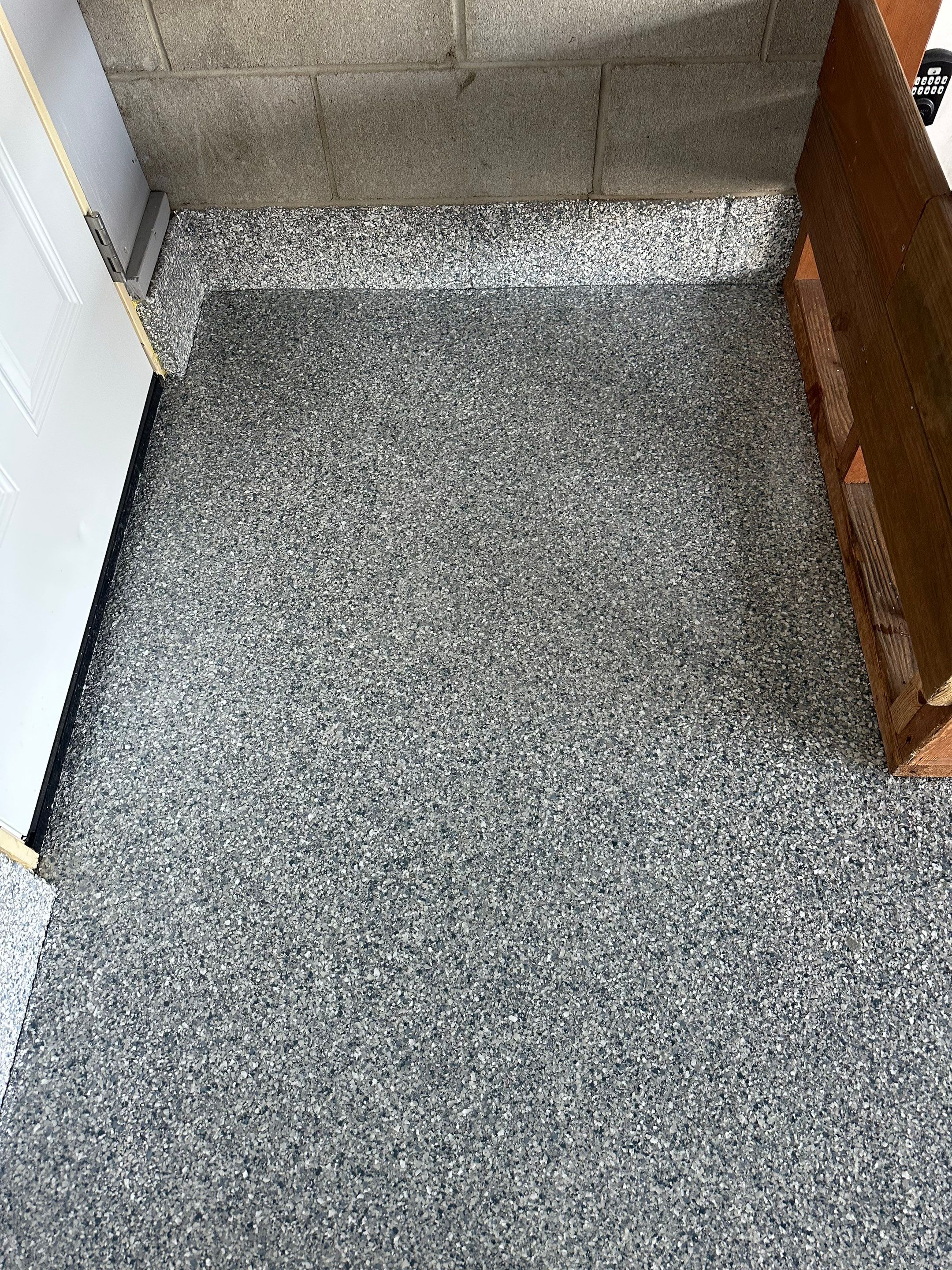 Multi-Colored Speckled Concrete Floor Coating Installation in Sioux Falls by Select Painting, Coatings & Garage Cabinets