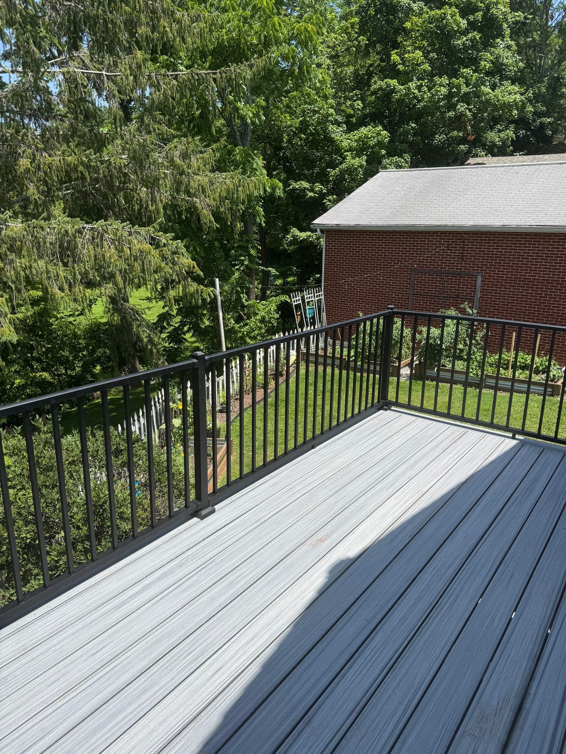 Elevated Composite Deck Rebuild with Black Metal Railing in Lewisburg by Walnut Hollow Decks & Outdoor Living