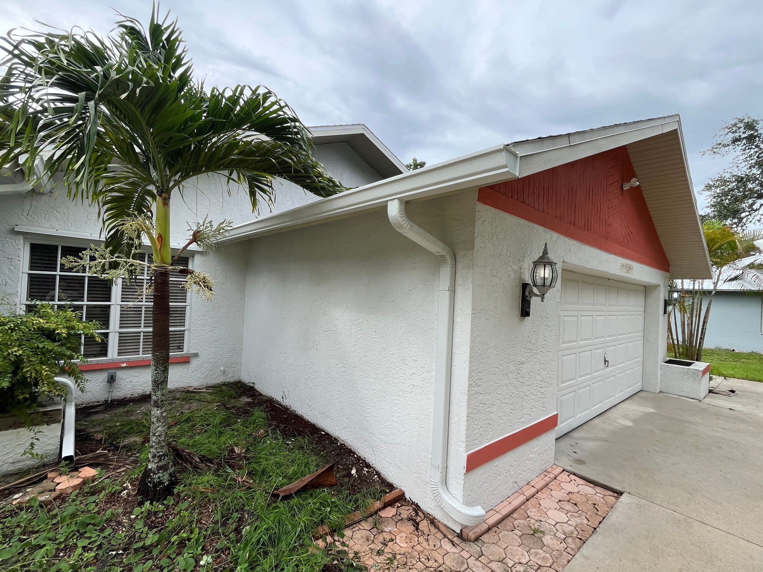 White Seamless Gutters with Splash Guards in North Fort Myers FL by Gutter Professor   by Gutter Professors