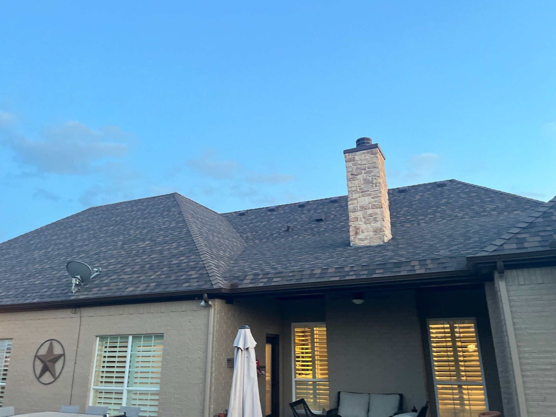 Cream brick/mixed stone with IKO Shadow Brown by Tejas Roofworks + Restoration