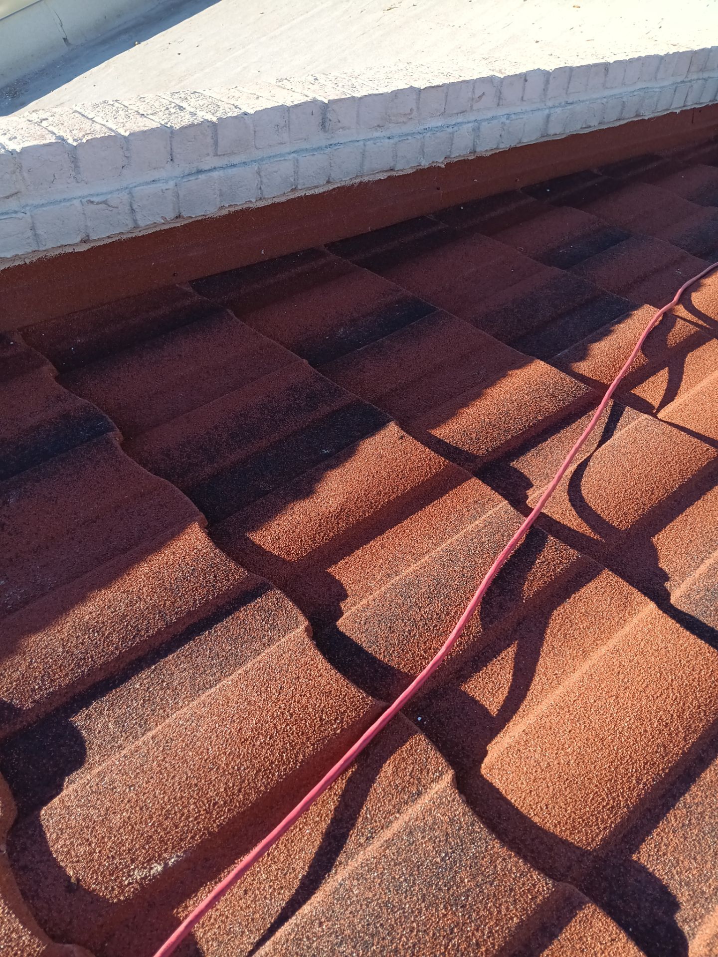 Off with the Tile and on with the TILCOR stone coated metal.  by Bayfront Roofing and Construction