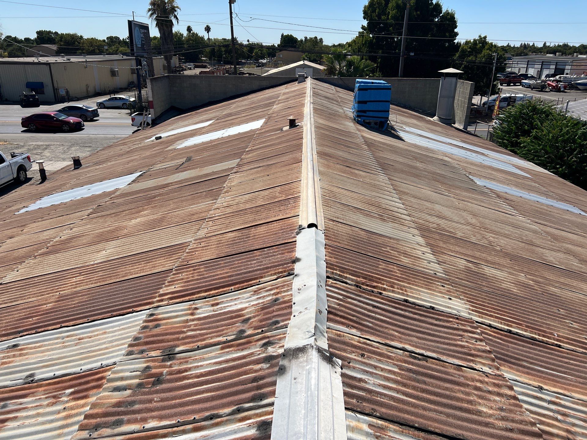Spray foam and coatings using Conklin Benchmark/ PUMA XL acrylic coatings over metal and foam by Straight Edge Roofing Inc