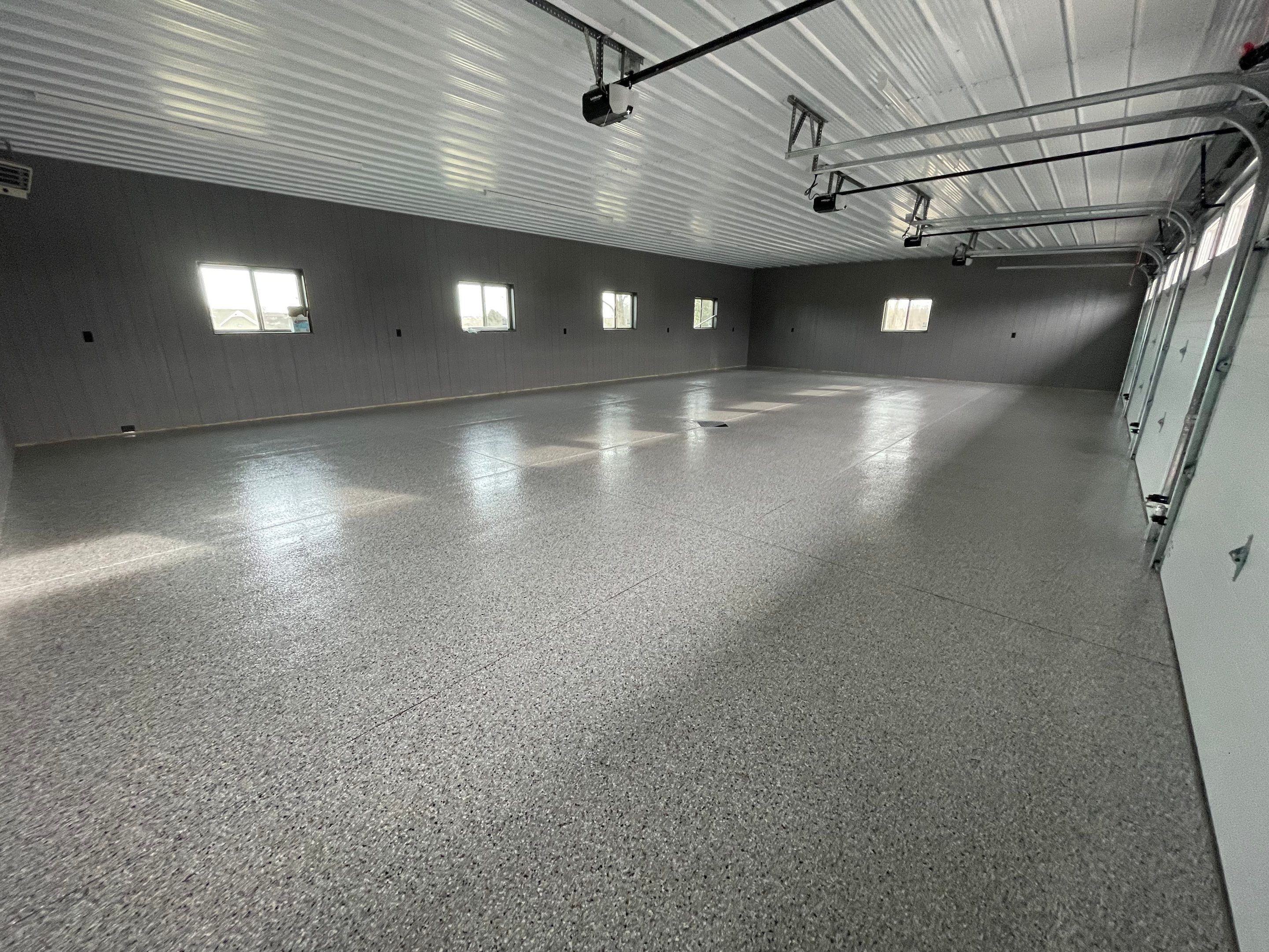 Speckled Epoxy Floor Coating for Large Shop in Rock Valley by Select Painting, Coatings & Garage Cabinets