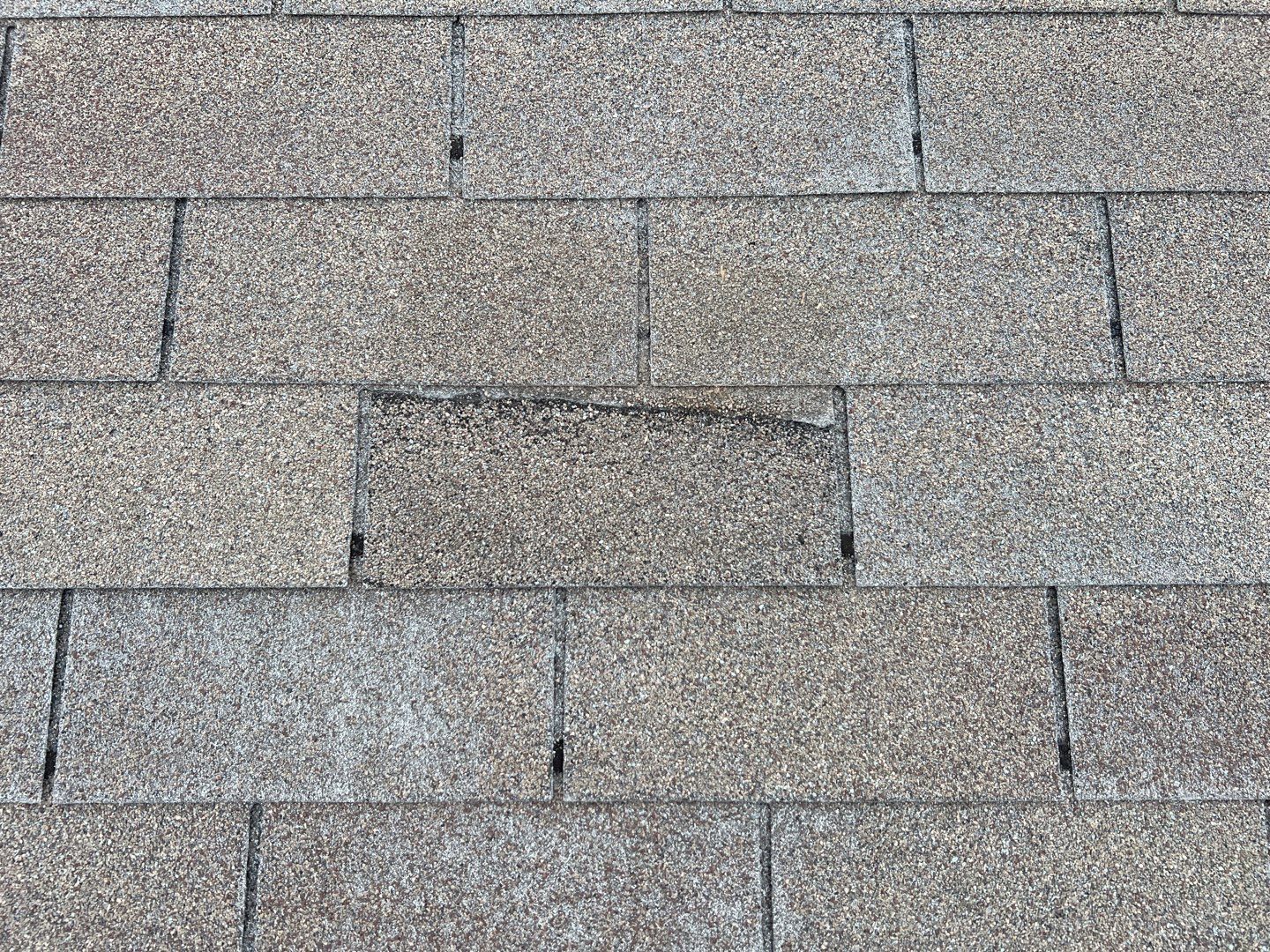 Wind damaged roof replacement by Oakwood Roofing and Construction, LLC