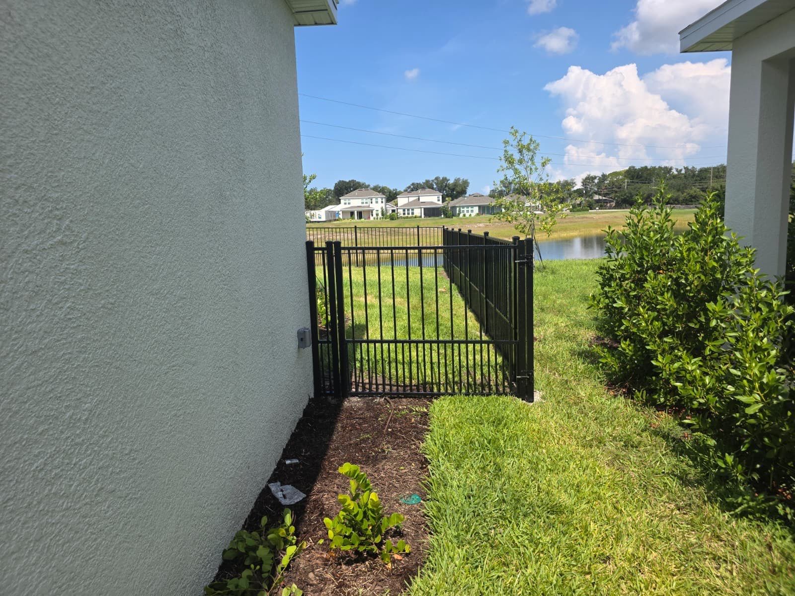 Black Aluminum Puppy Picket Fence Installation in Nokomis by True Fence LLC