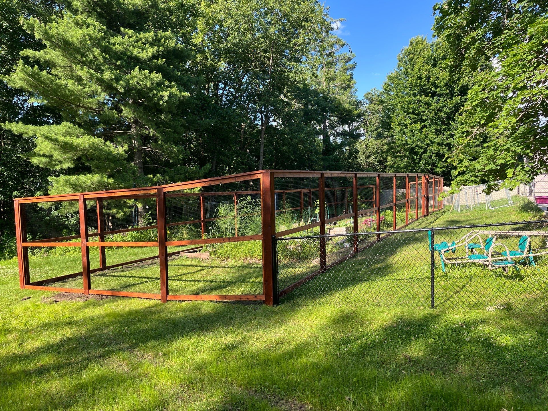 Stained Cedar Mahogany Garden Fence and Raised Bed Enclosure in Cedar Falls by Perfect Picket Fence and Stain